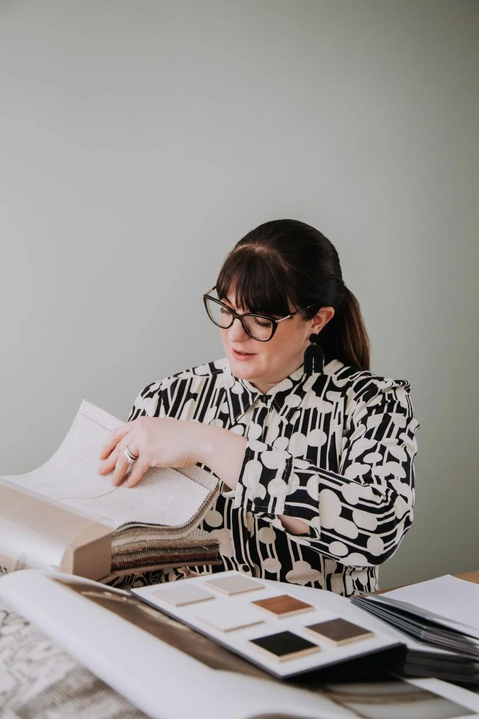 Interior designer looking at her work on a brand shoot in Colchester Essex