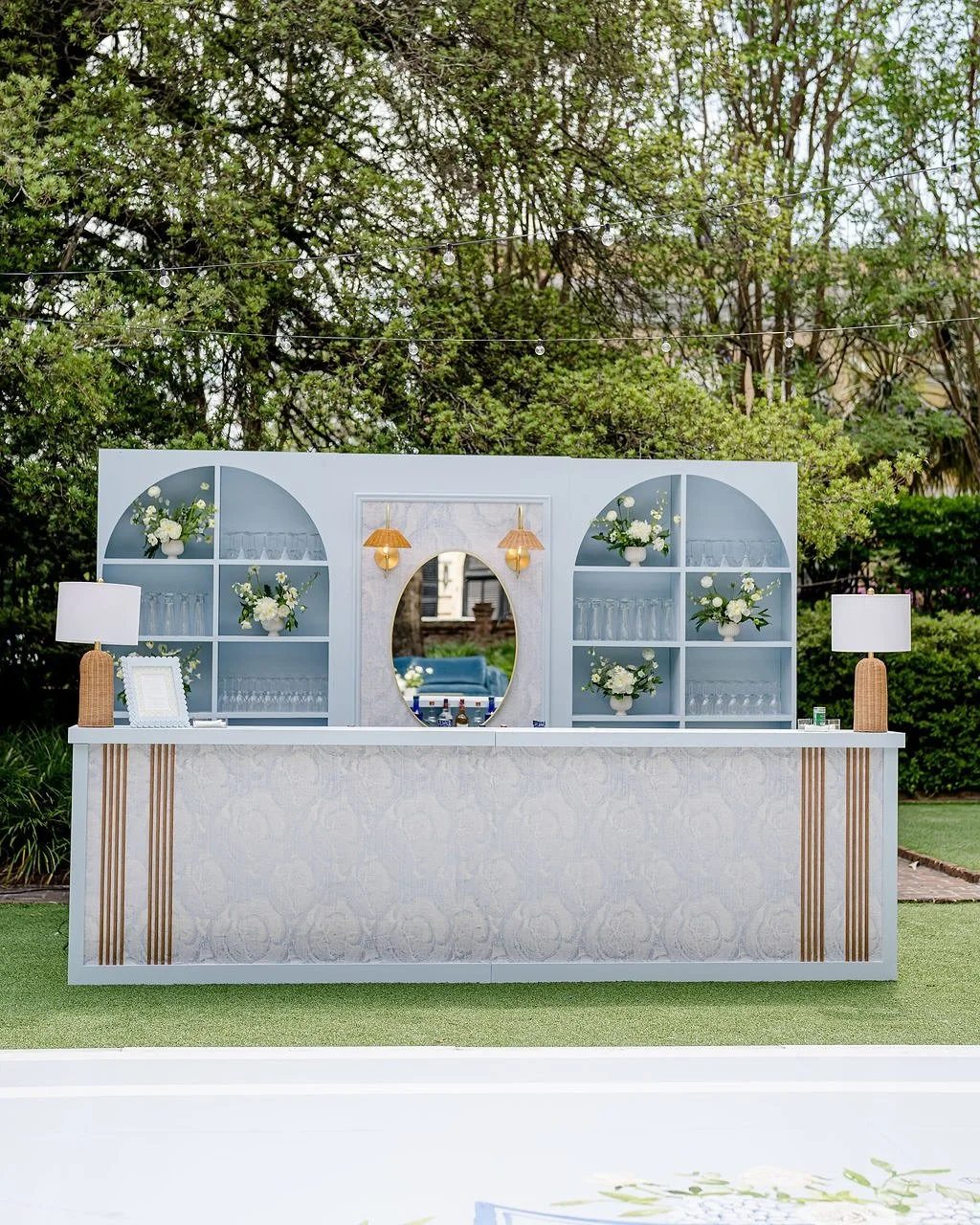 Custom at every turn: a bar that became the main character and patterned in their very own napkins, a dance floor wrapped in their crest, luxe drapery to provide softness throughout, cane details woven from seating to signage and bible verses hung in
