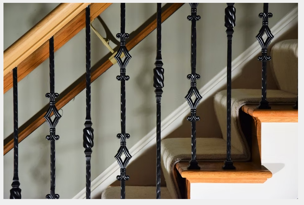 Detail of interior stair railing featuring balusters and newel post, showcasing precision-crafted stair parts by Empire Stairworks.