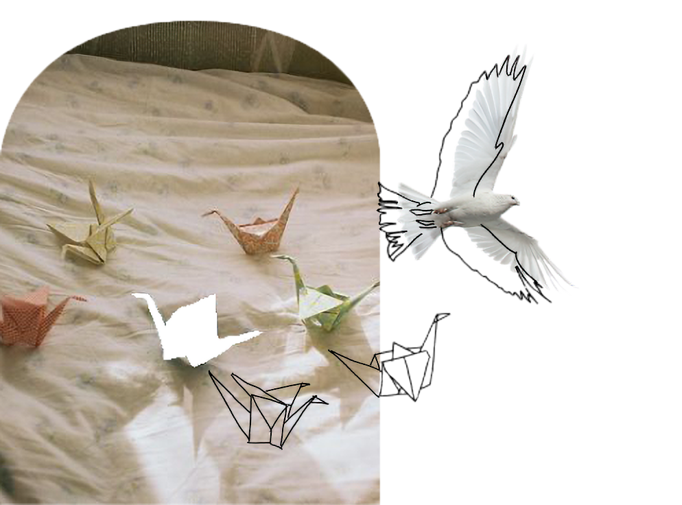 Origami paper cranes, a butterfly, and a bird on a light-colored fabric background.