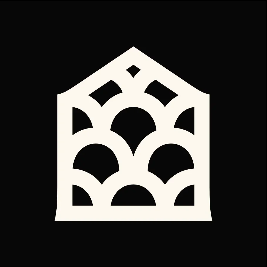 A white abstract architectural structure with arches and geometric cut-outs on a black background.