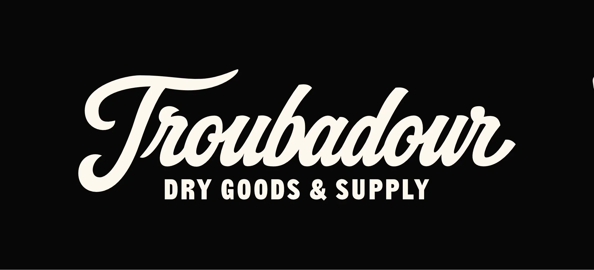 Logo for Troubadour Dry Goods & Supply with white script and block text on black background.