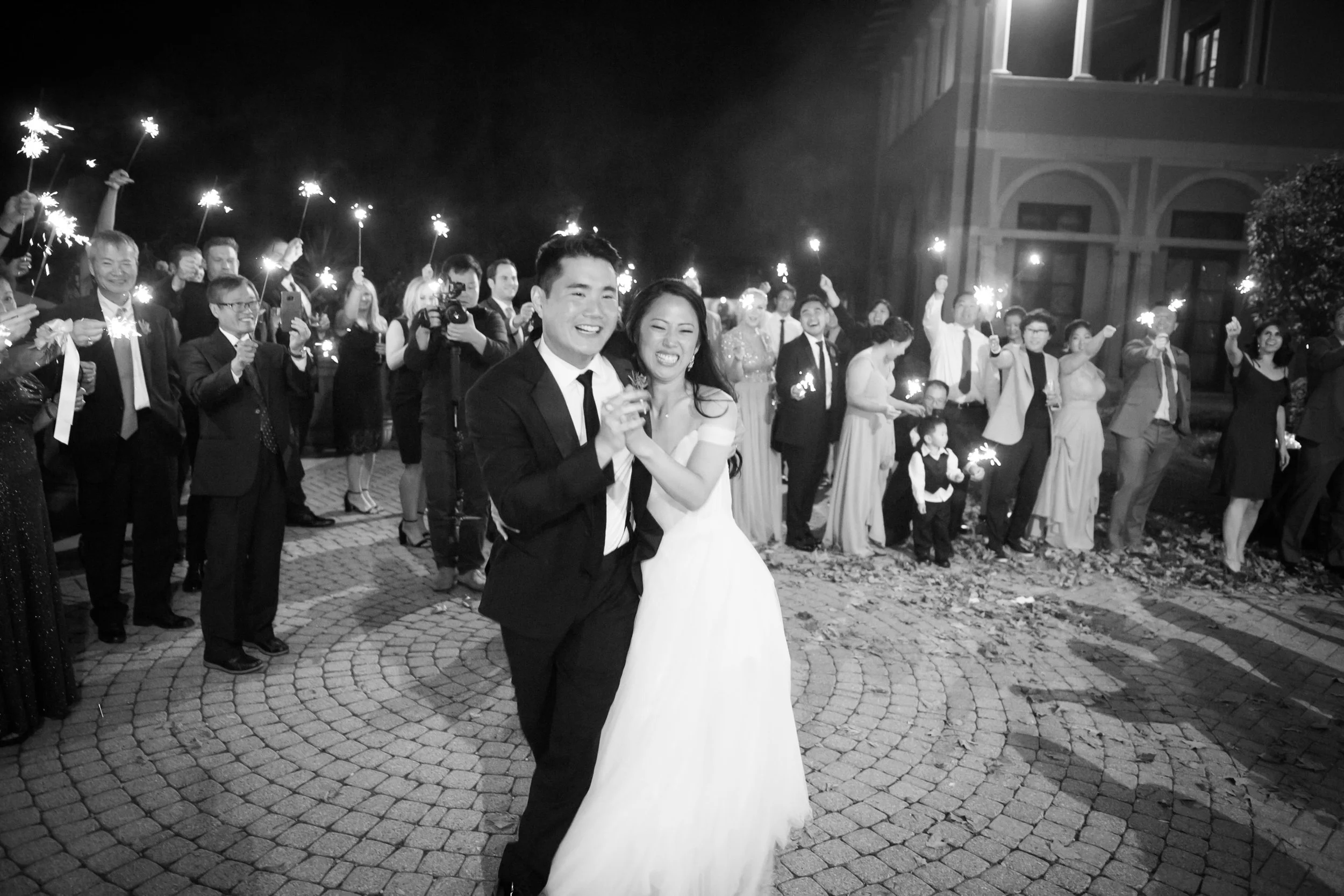 bride and groom exit reception under sparklers average cost for a wedding photographer 