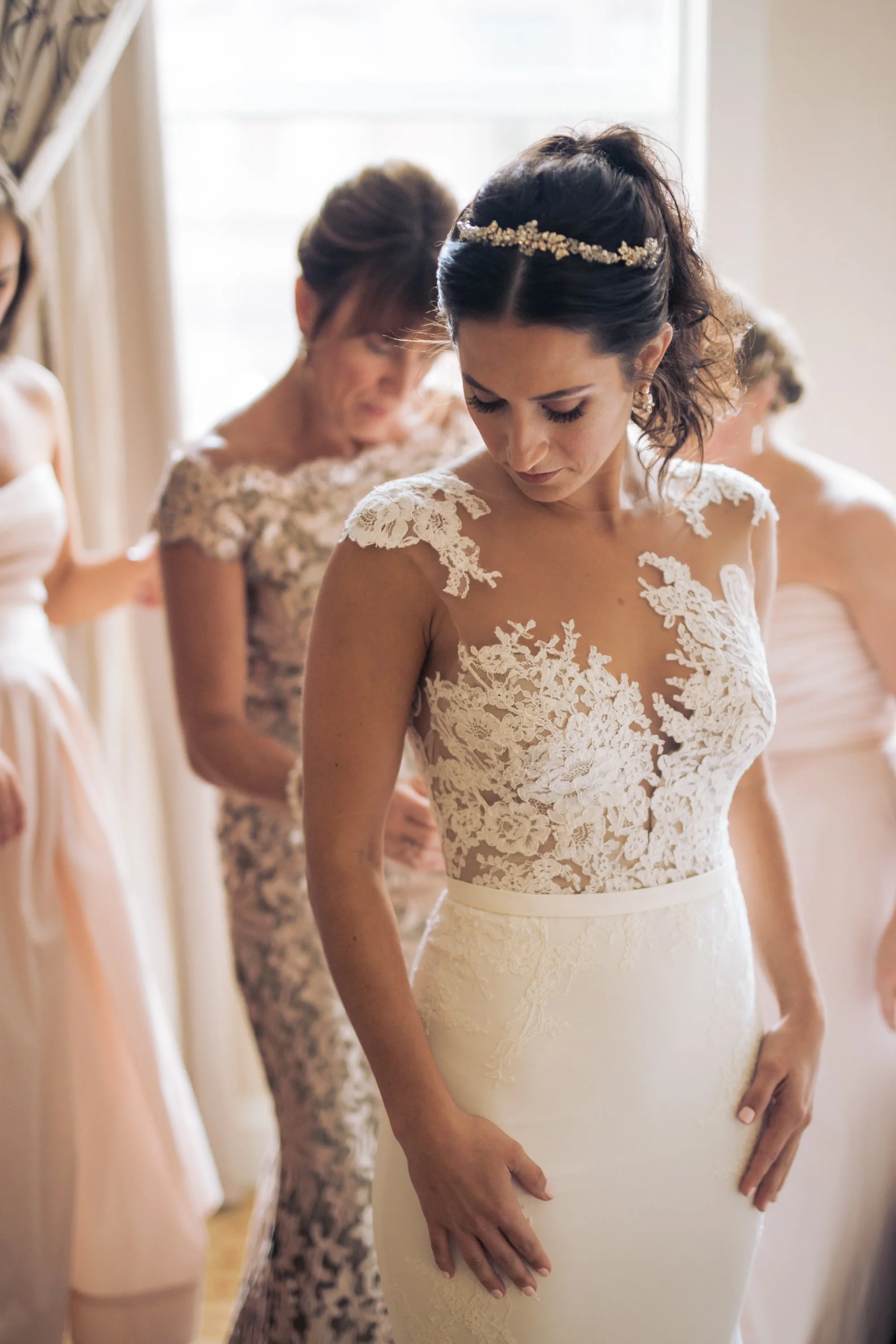 bride dress getting dressed with mother wedding photographer near me 