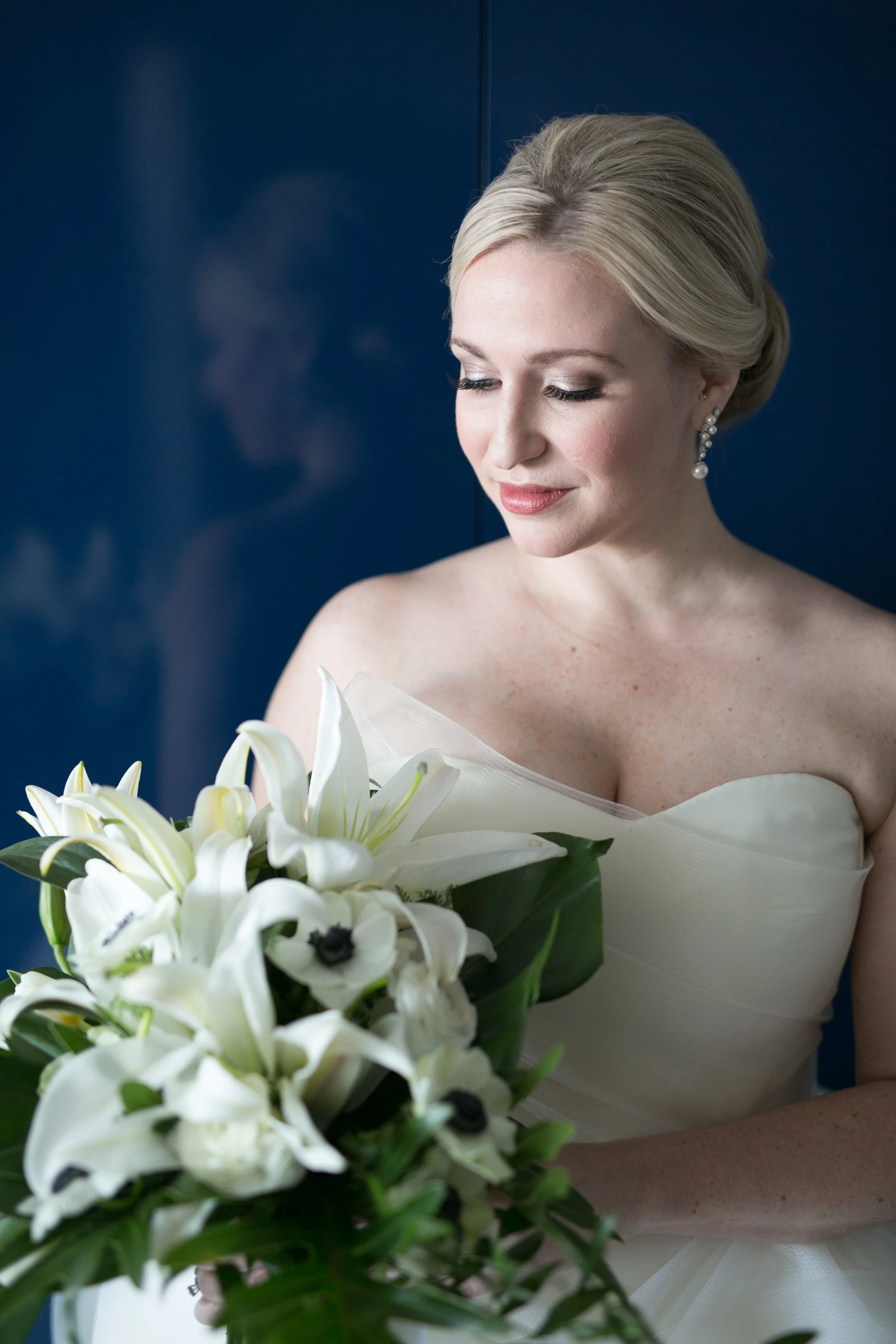 bride getting dressed smiling with flowers average price for wedding photographer
