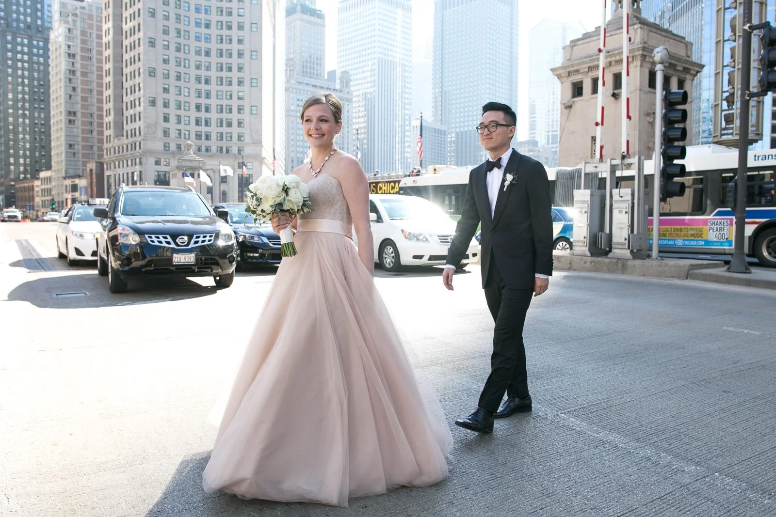 bride and groom walking on sidewalk michigan avenue wedding photography