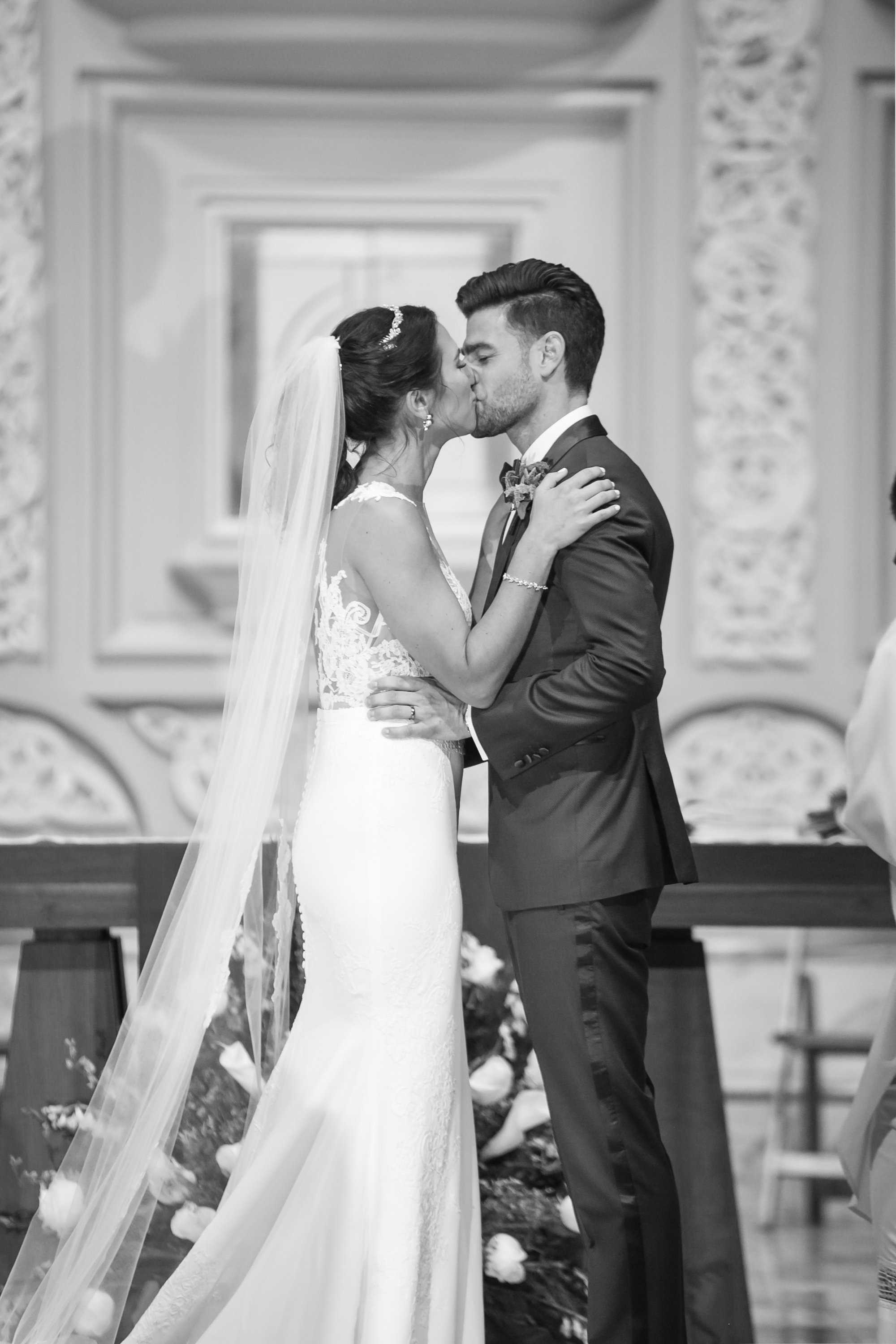 bride and groom first kiss at ceremony Chicago wedding photographer near me