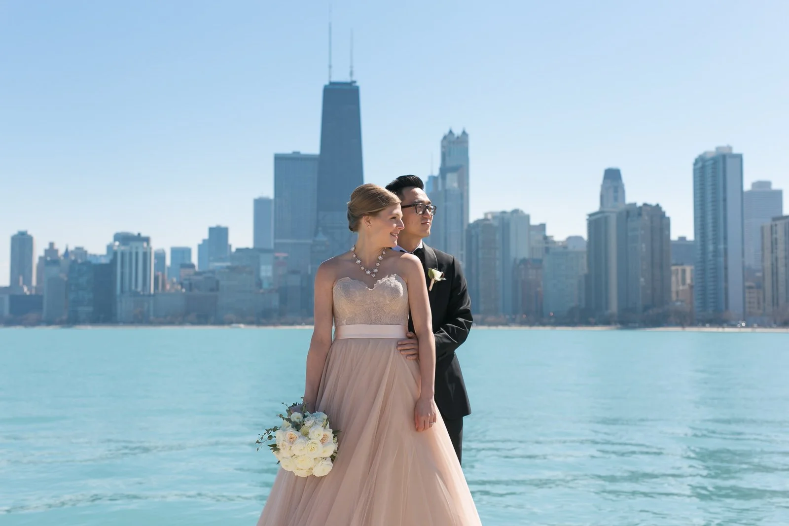 groom holding bride with bouquet north avenue beach lake michigan wedding photography near me 
