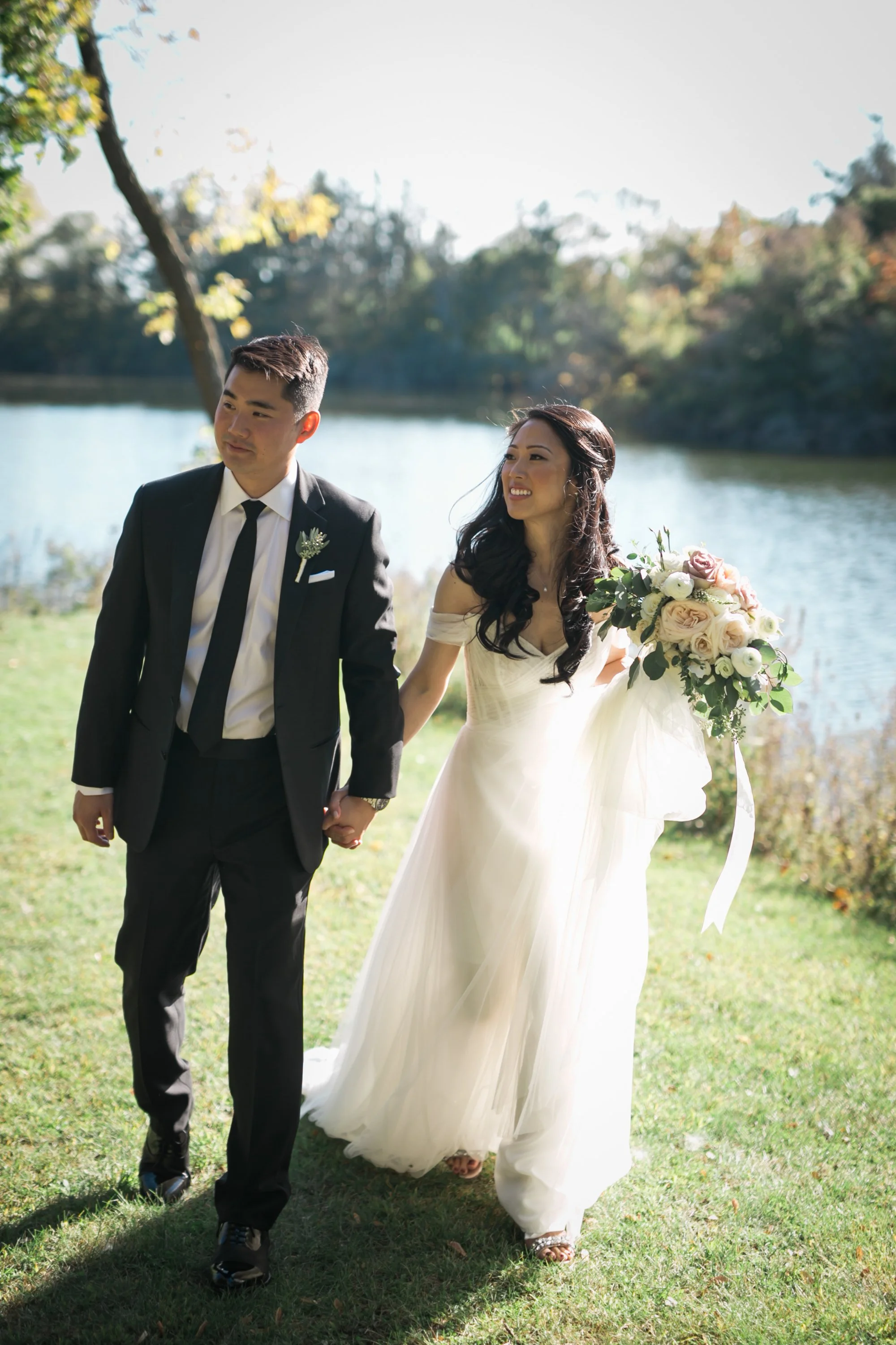 bride and groom holding hands walking wedding photography