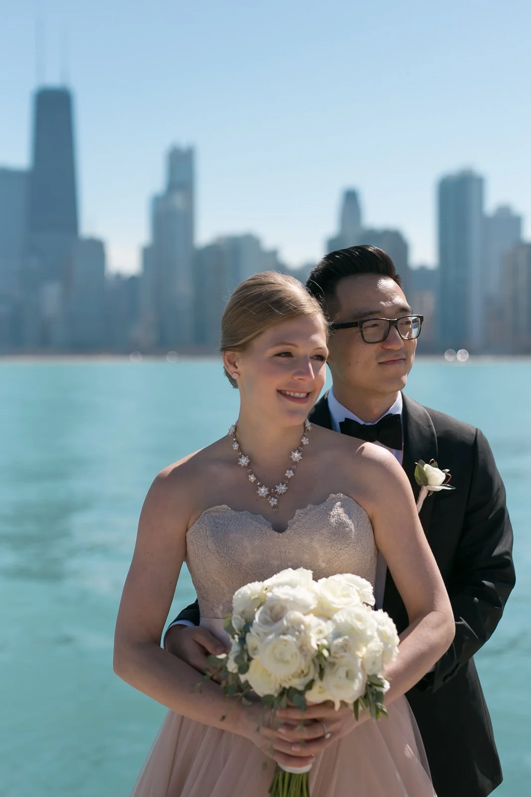 groom holding bride with bouquet north avenue beach lake michigan wedding photography near me 