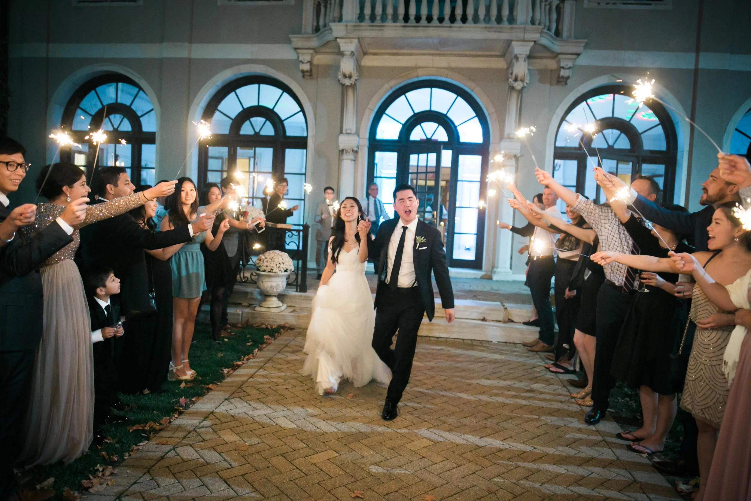 bride and groom exit reception under sparklers average cost for a wedding photographer 