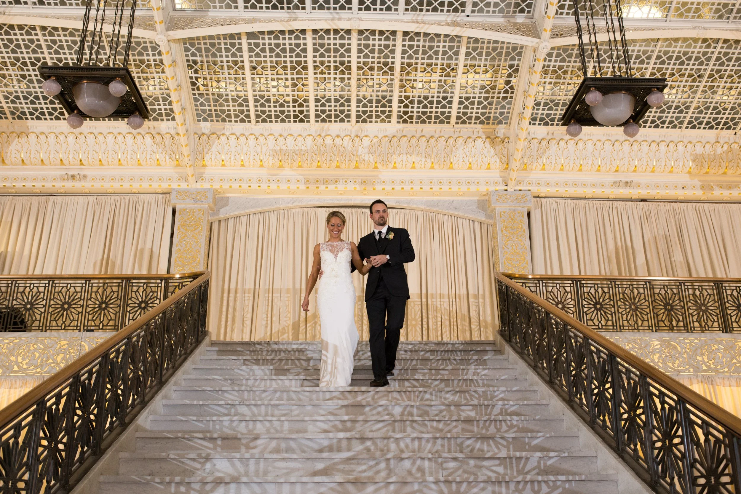 bride and groom ascending down a flight of stairs Chicago wedding photographers on a budget 