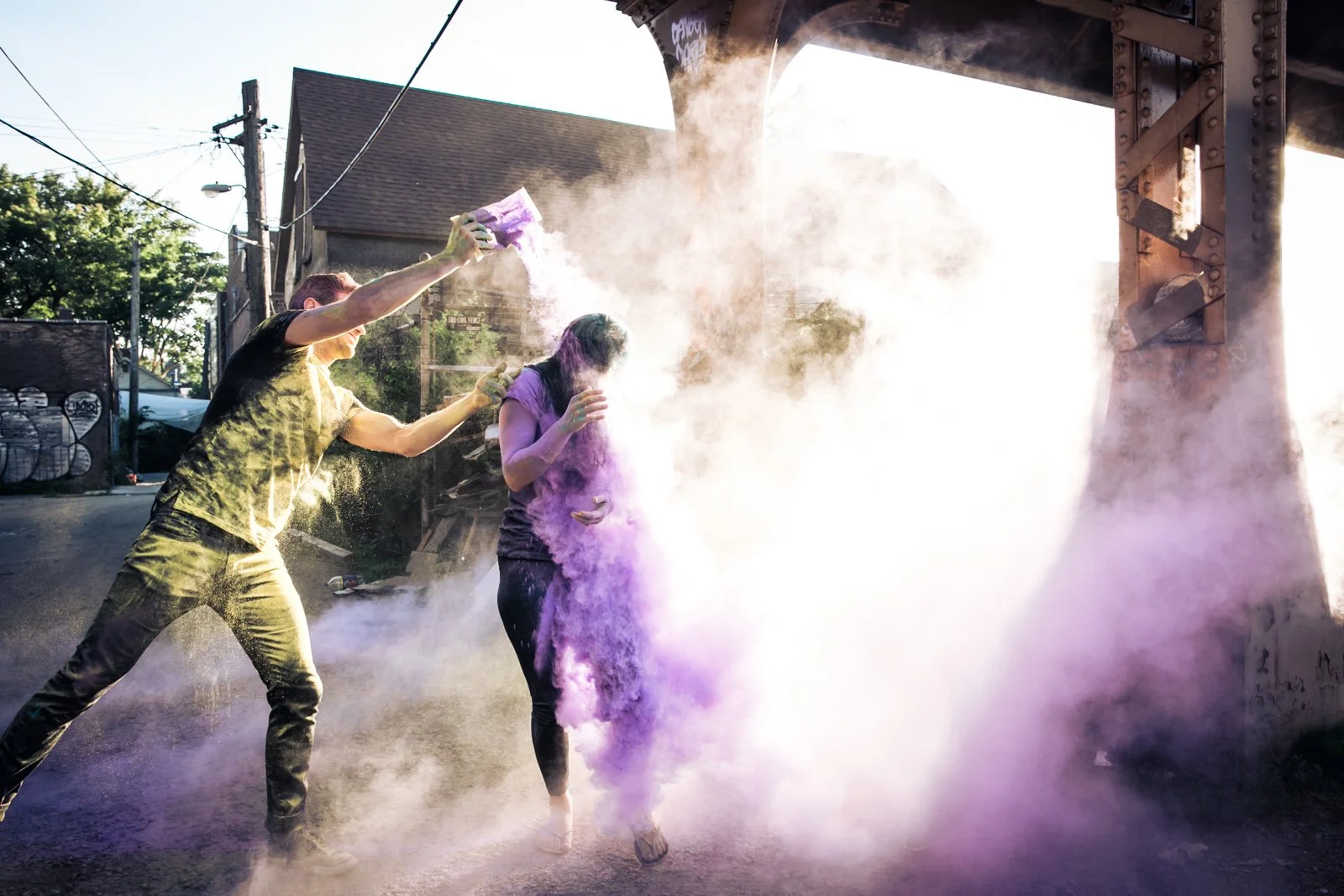 holi powder engagement photo session under el track Chicago wedding photographer near me