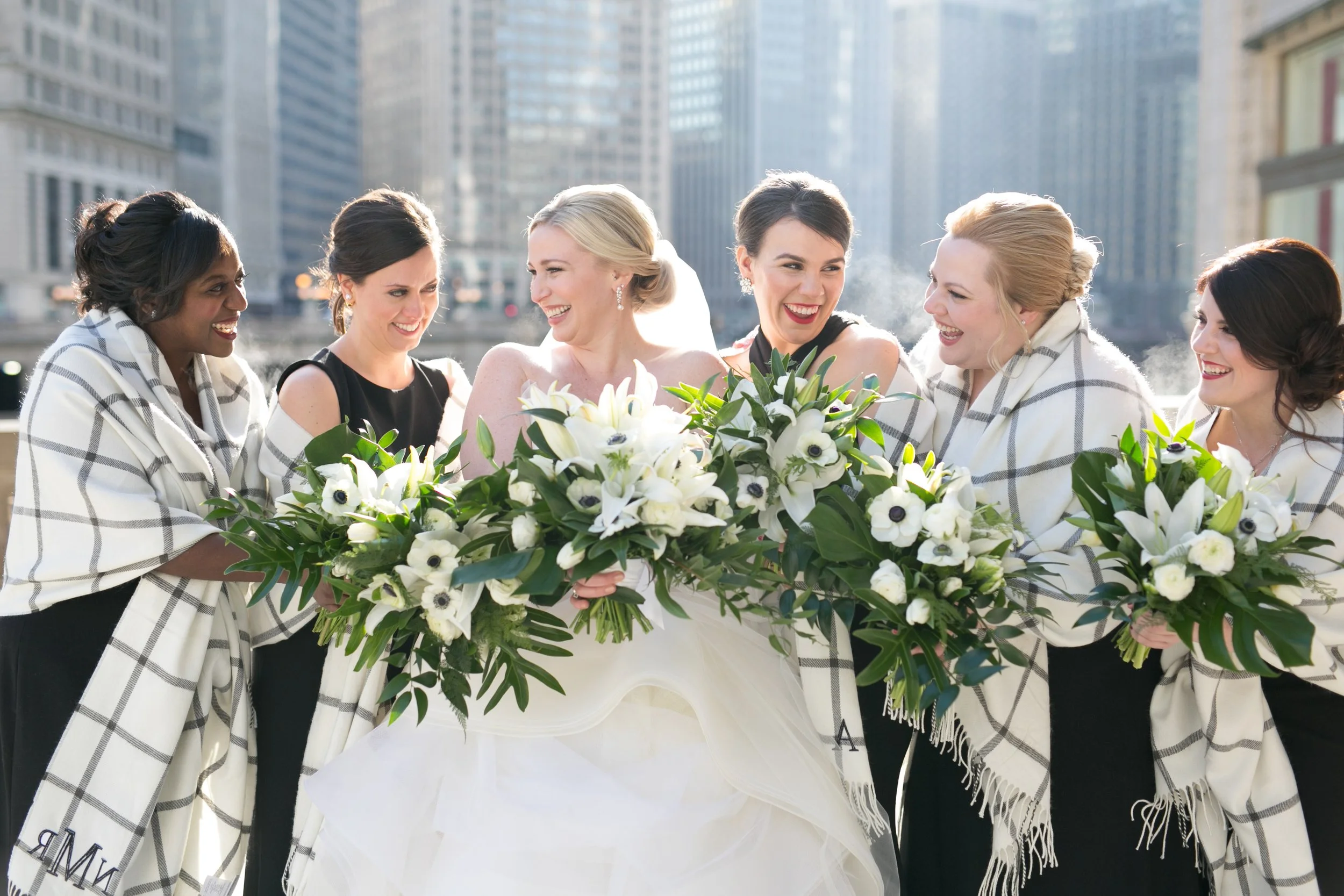 bride with bridesmaids Chicago downtown Wrigley Building wedding photography packages