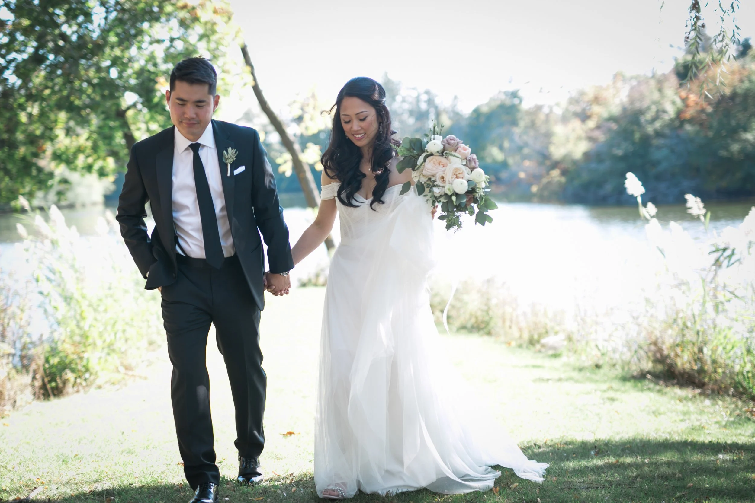 bride and groom holding hands walking wedding photography
