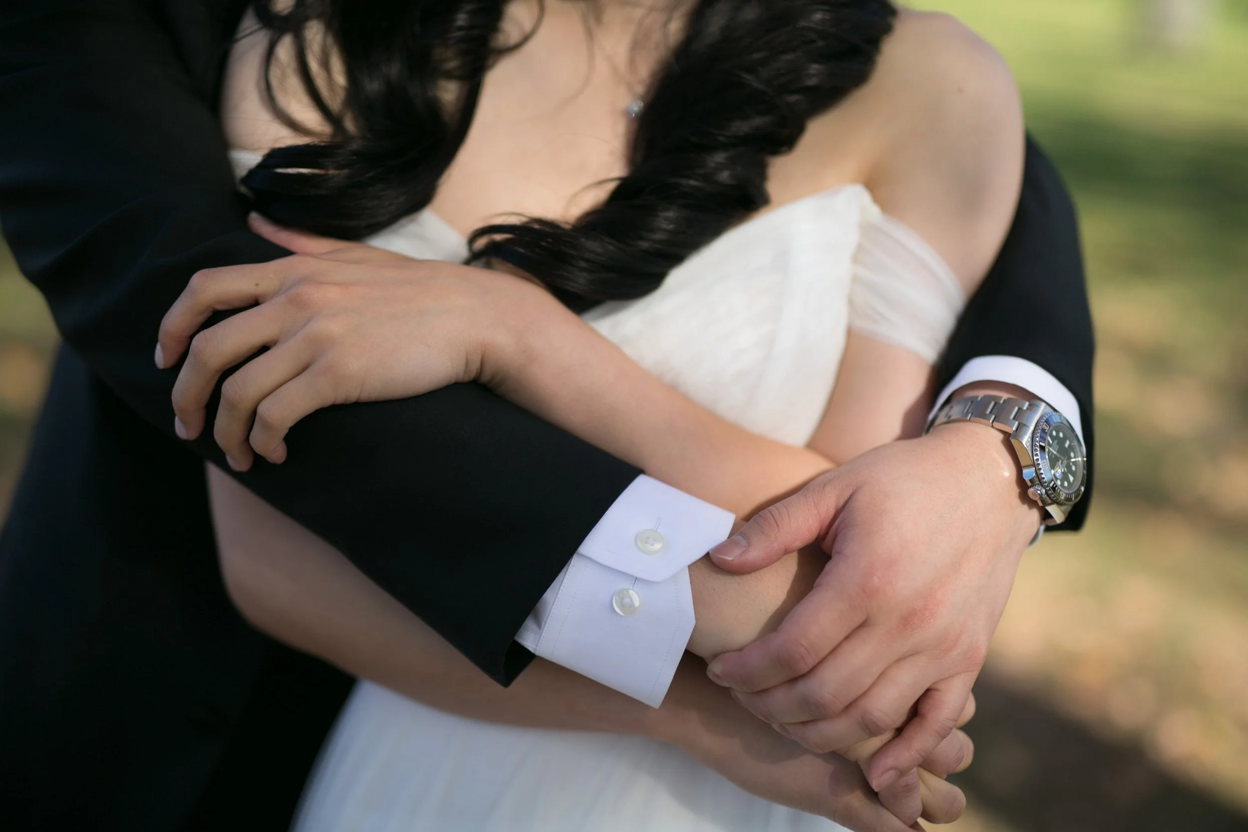 bride and groom embracing holding hands hugging wedding photography