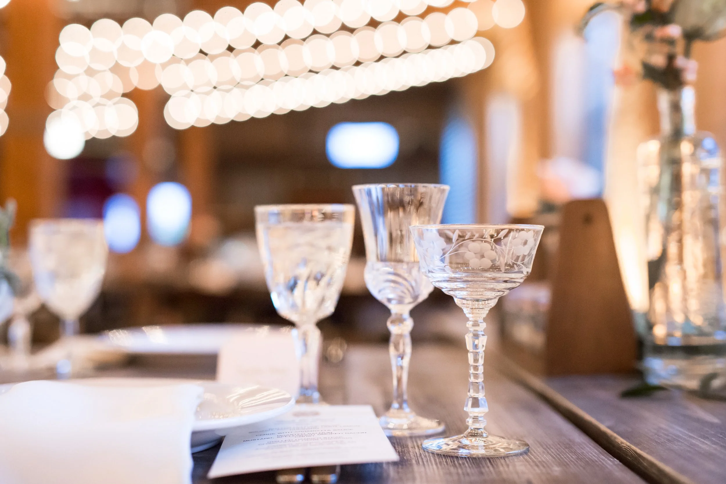 wedding reception table glasses centerpieces with flowers lights wedding photographer near me