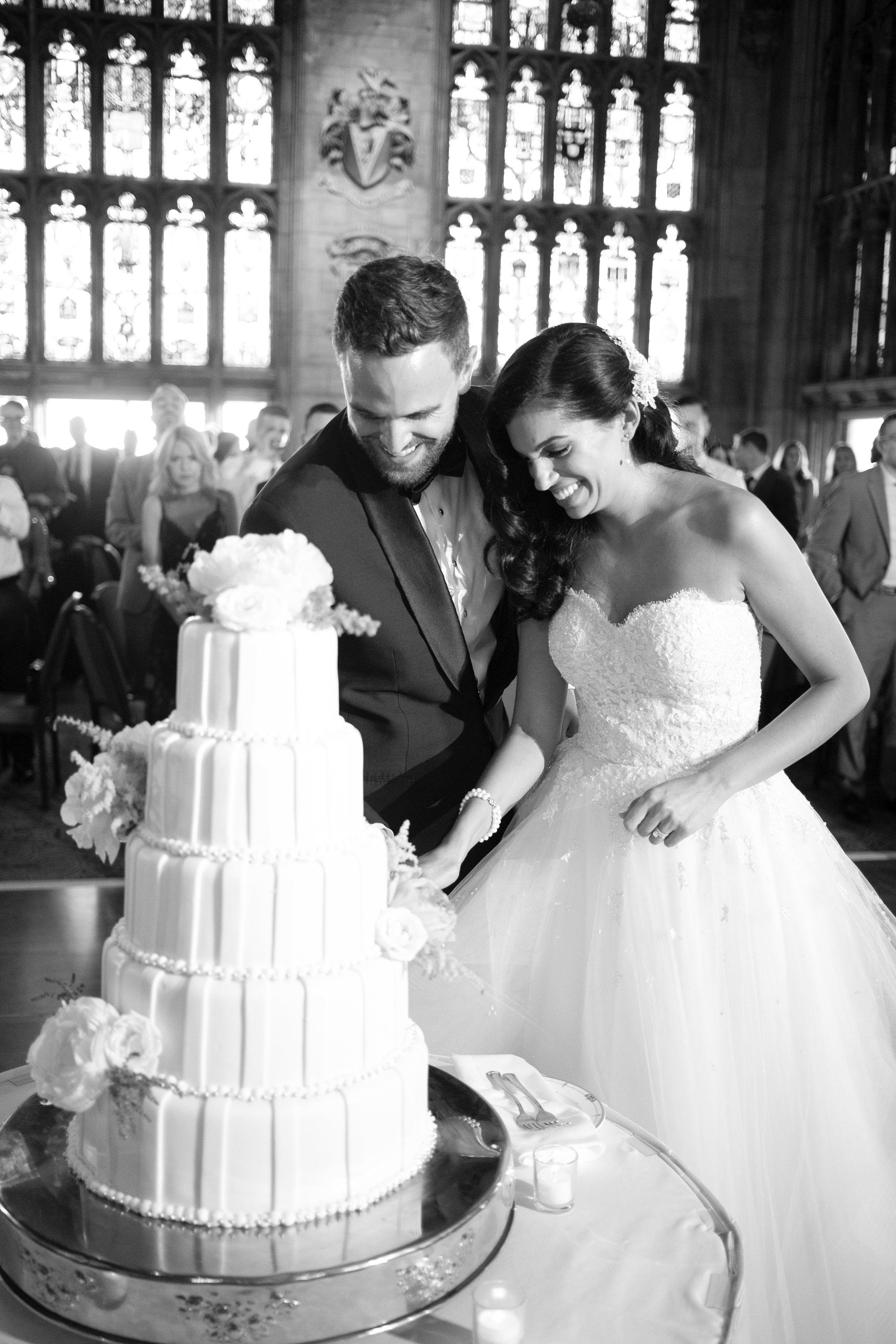 Bride and groom cutting cake for first time Chicago Wedding Photographer amazing timeless affordable