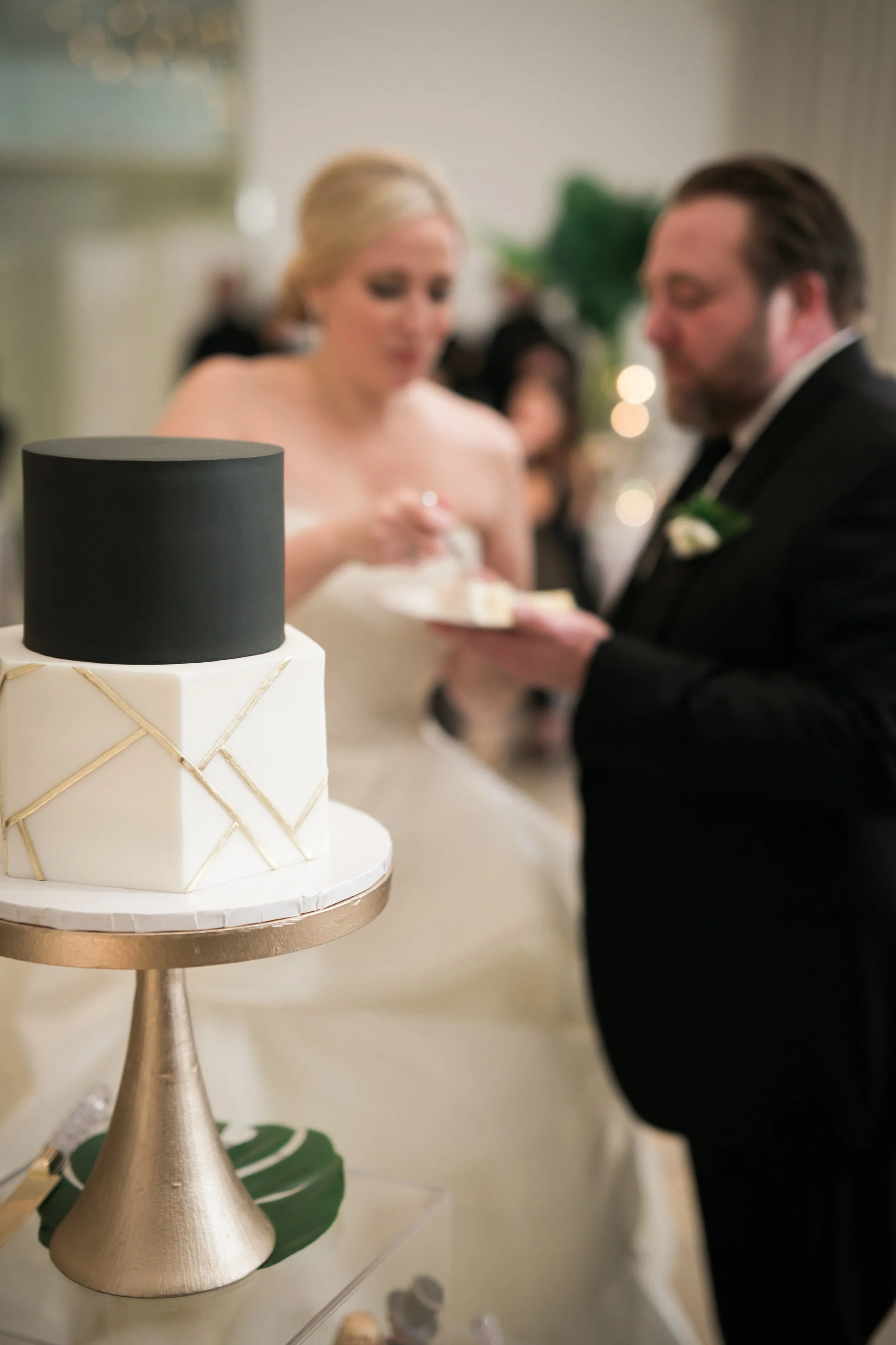 bride and groom cutting cake at reception Chicago wedding photographer near me 