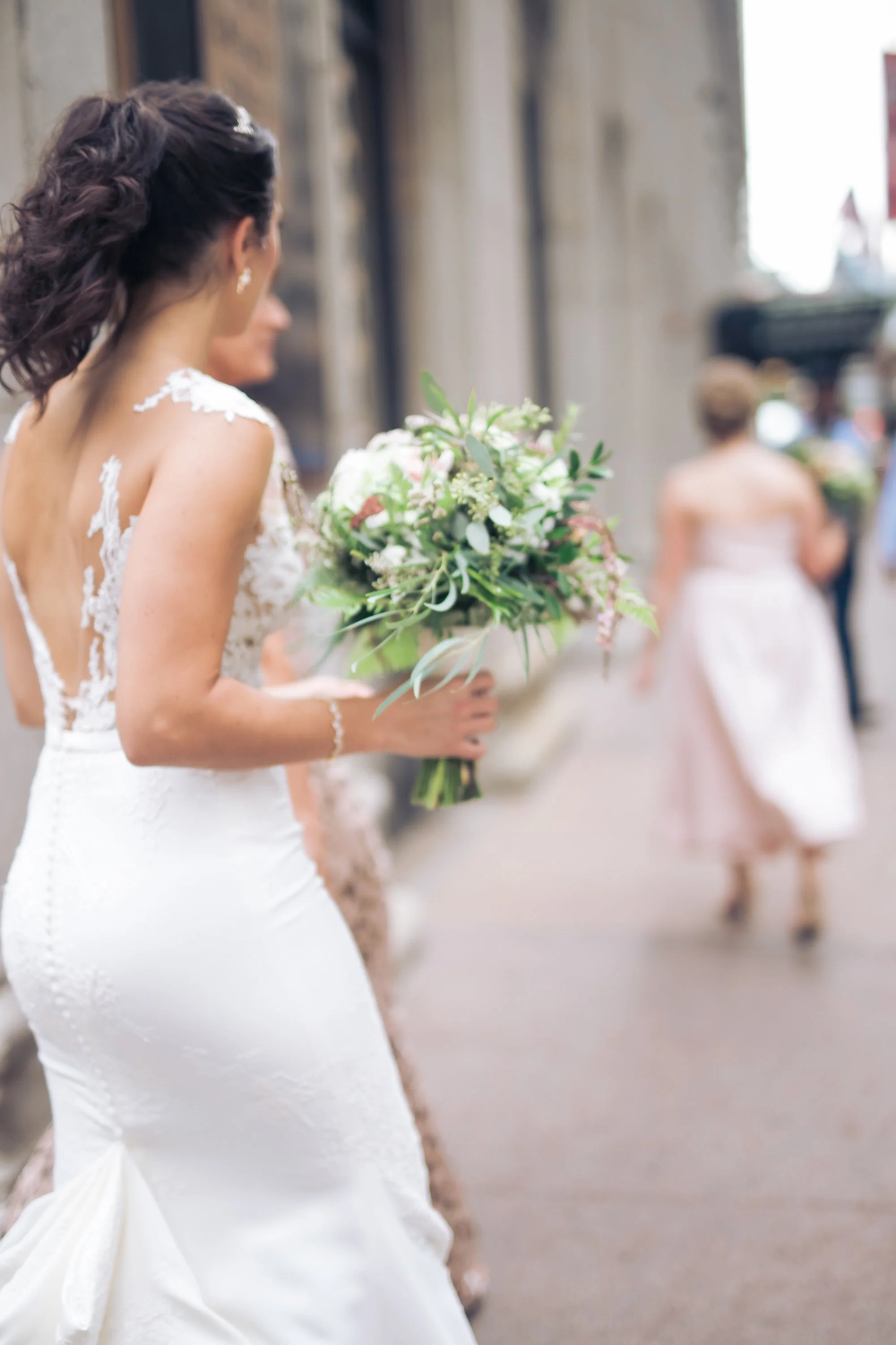bride walking down sidewalk wedding photographer in Chicago 