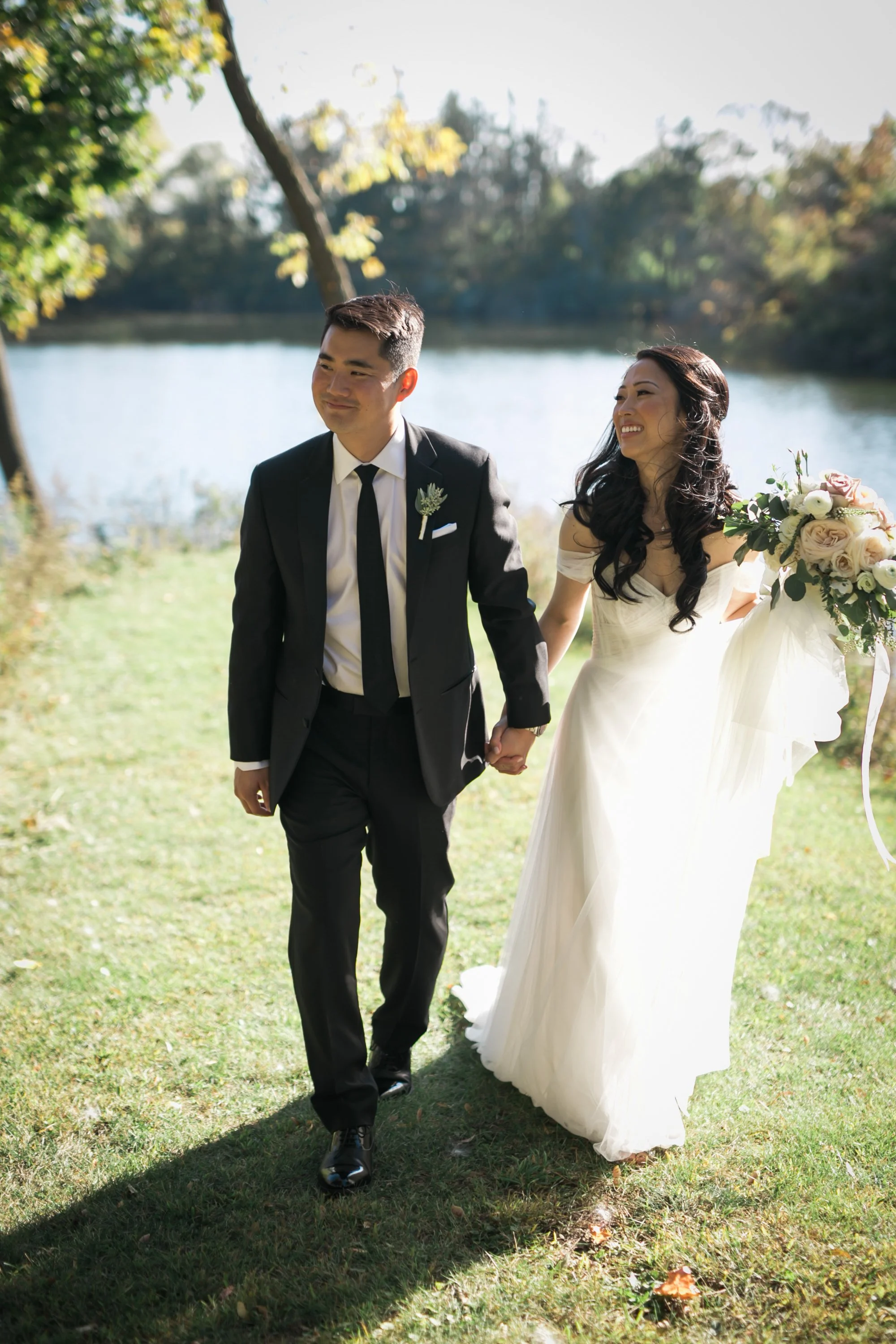 bride and groom holding hands walking wedding photography