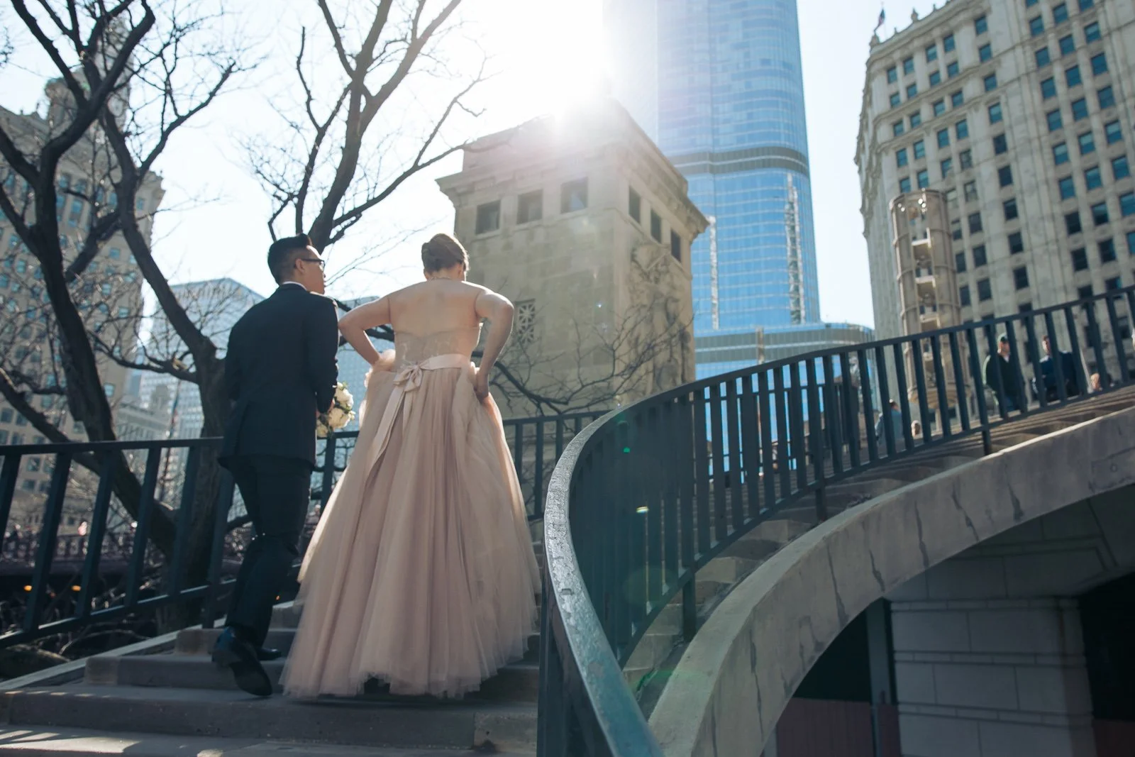 bride and groom walking up staircase sunny  michigan avenue wedding photography