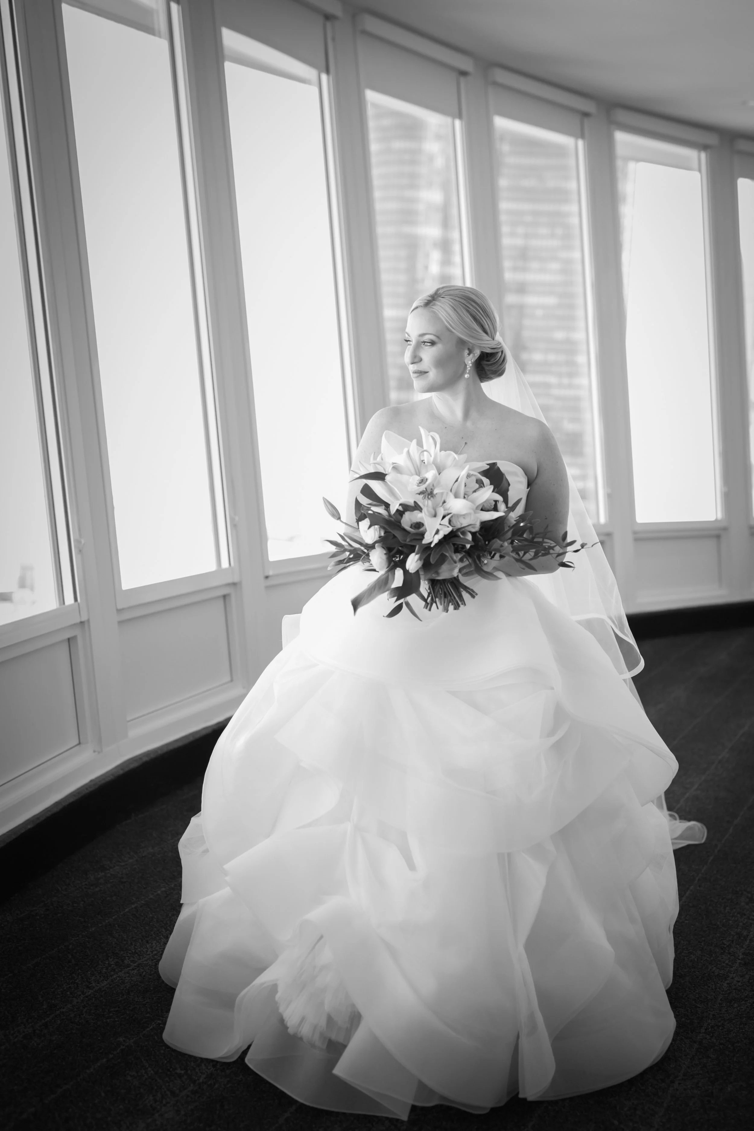 bride waiting for first look with groom looking out windows average price for wedding photographer