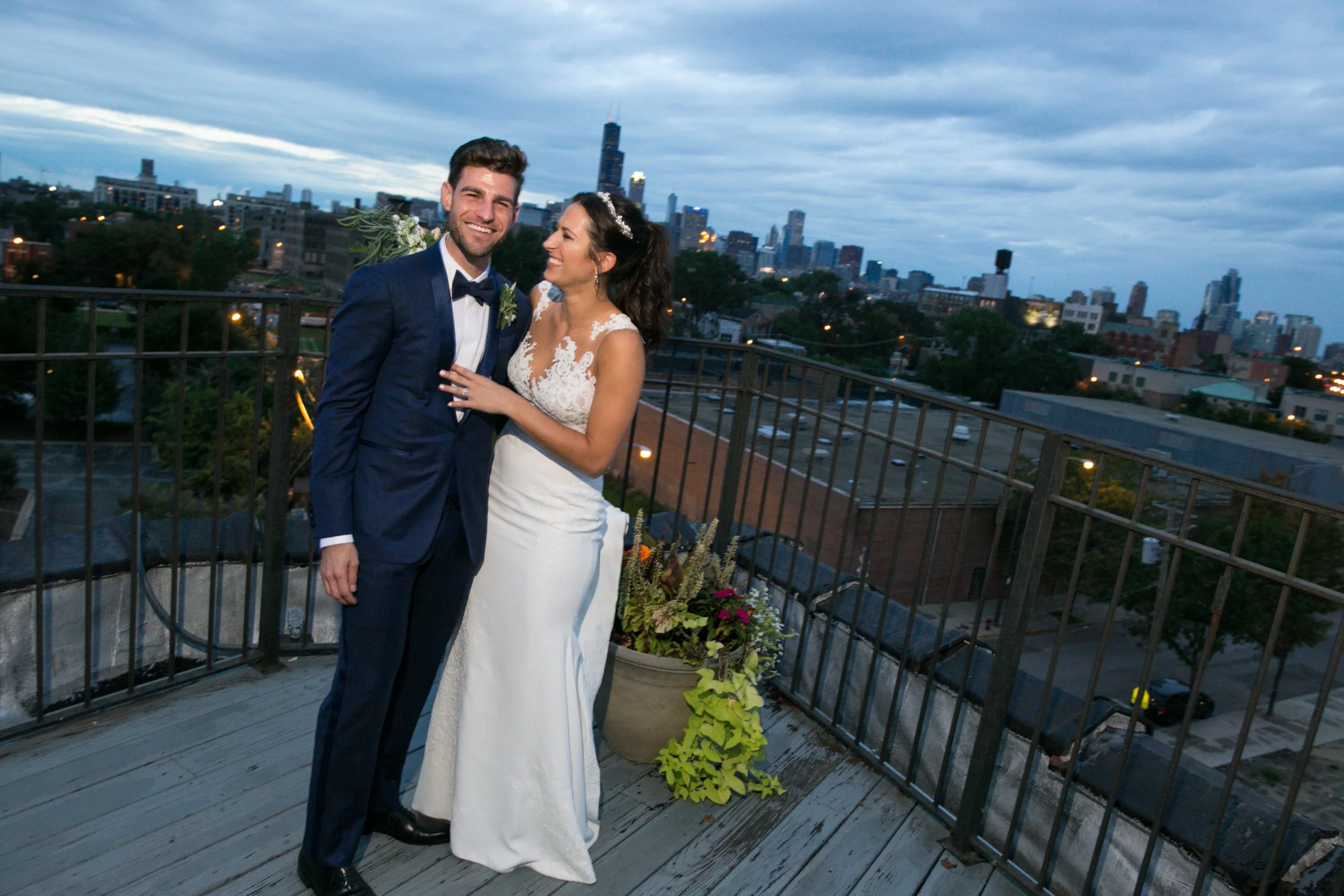 bride and groom laughing on rooftop Chicago skyline wedding photographer near me 