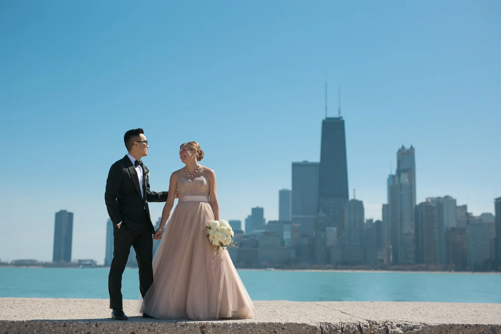 Chicago Wedding photography couple in front of skyline videographer near me