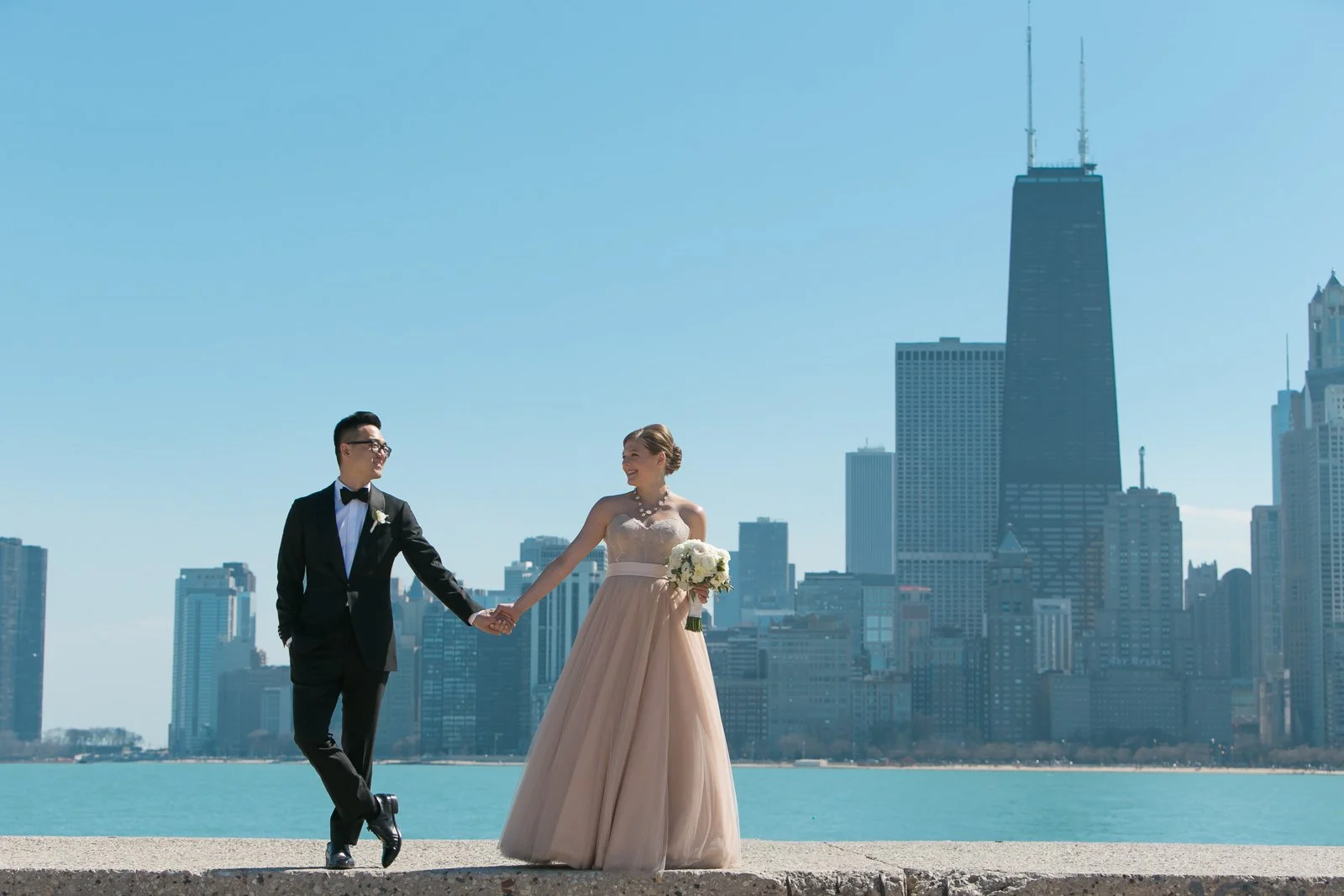 groom standing with bride with bouquet north avenue beach lake michigan wedding photography