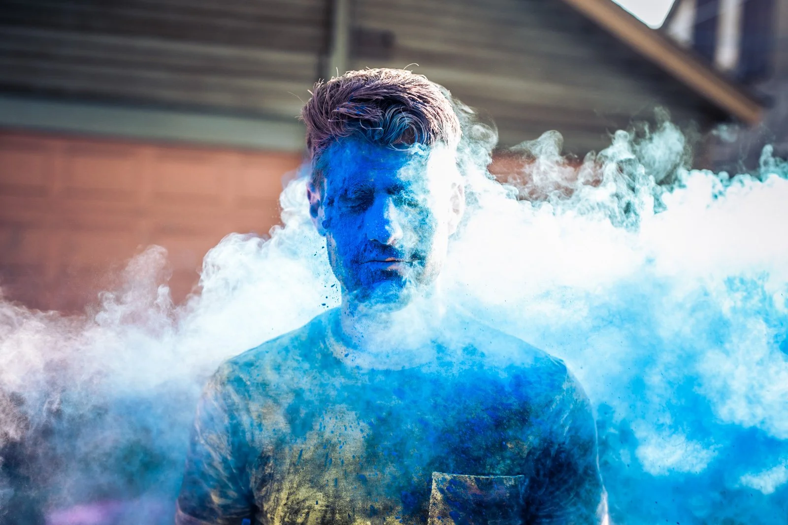 blue holi powder engagement photo session under el track Chicago wedding photography 