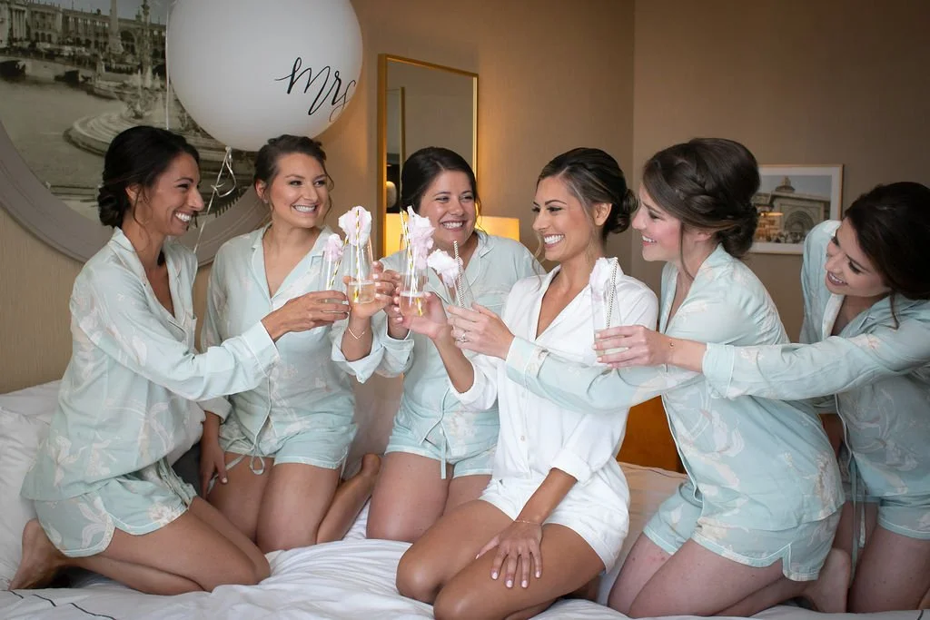 Bridesmaids cheersing for the wedding photographer in a downtown Chicago hotel