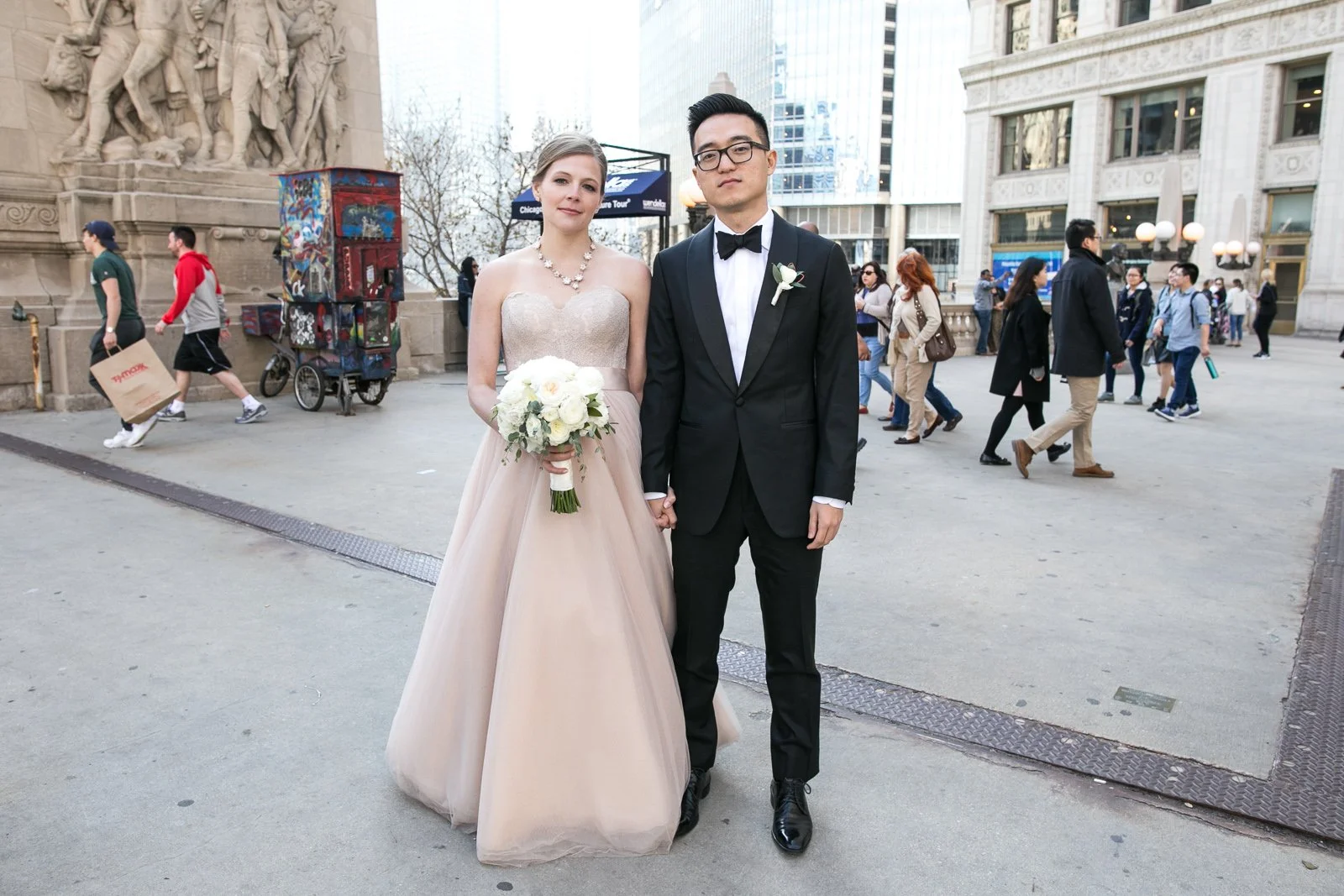 bride and groom standing on sidewalk michigan avenue wedding photography