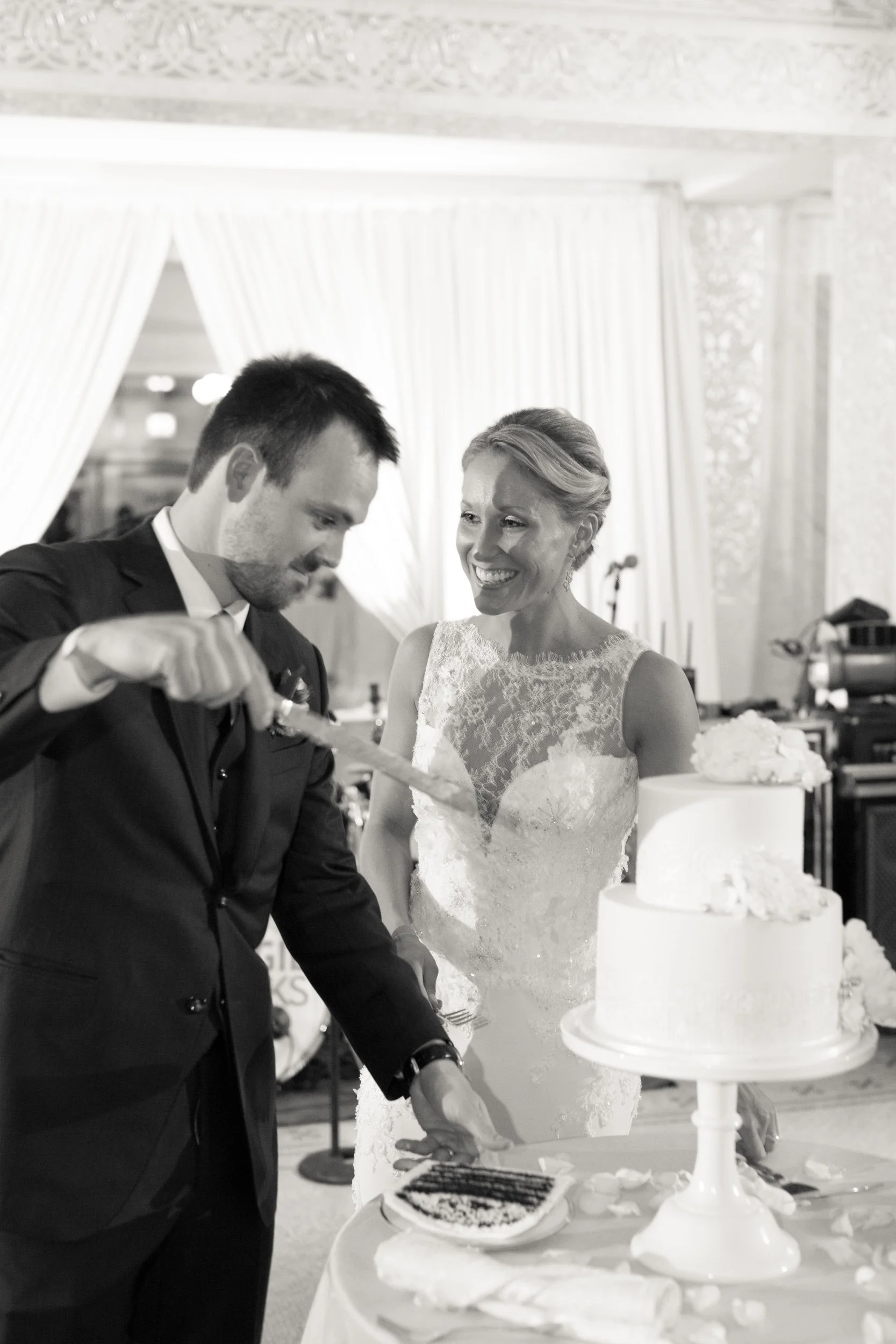 groom cutting cake Chicago wedding photographers near me 
