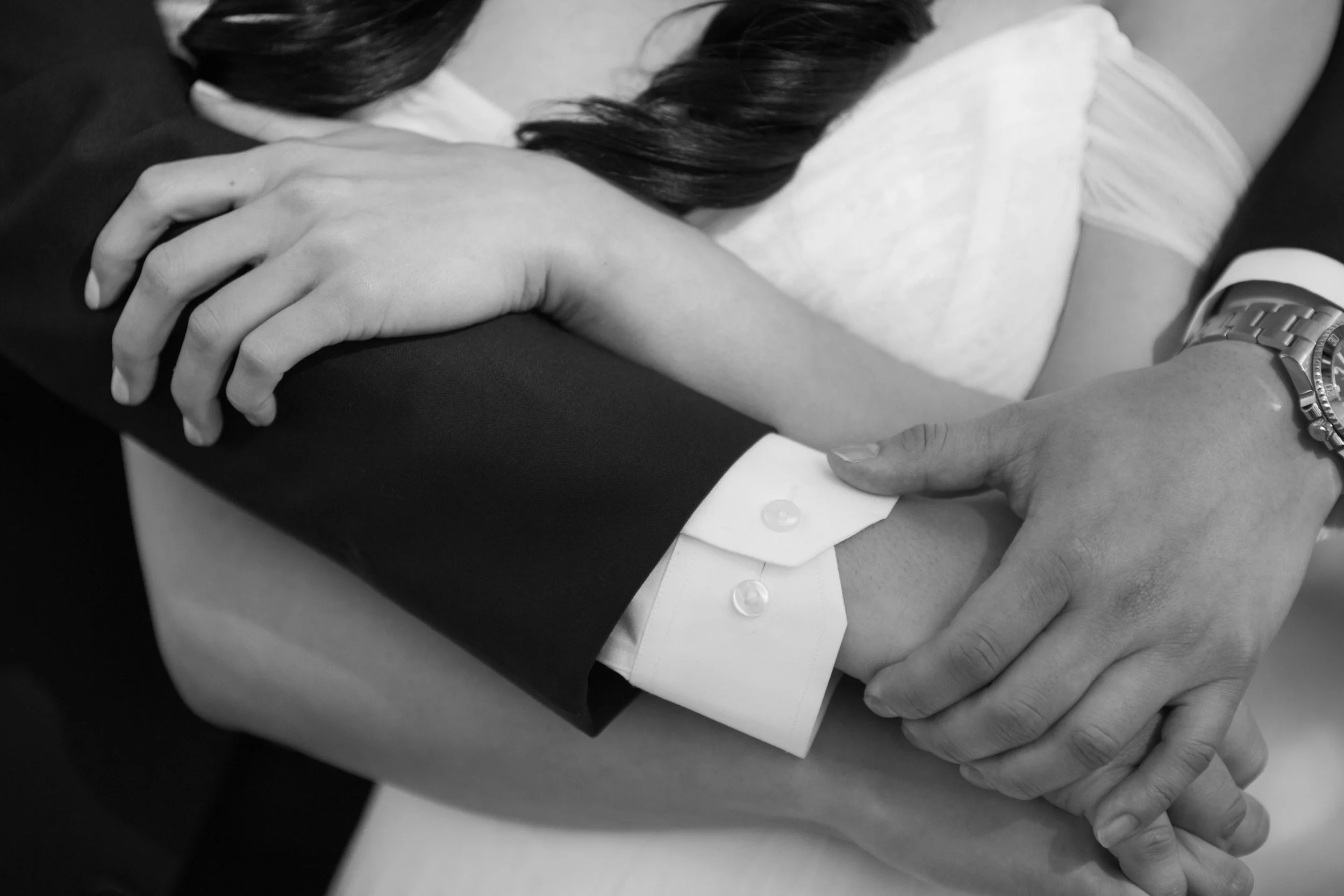 bride and groom embracing holding hands hugging wedding photography