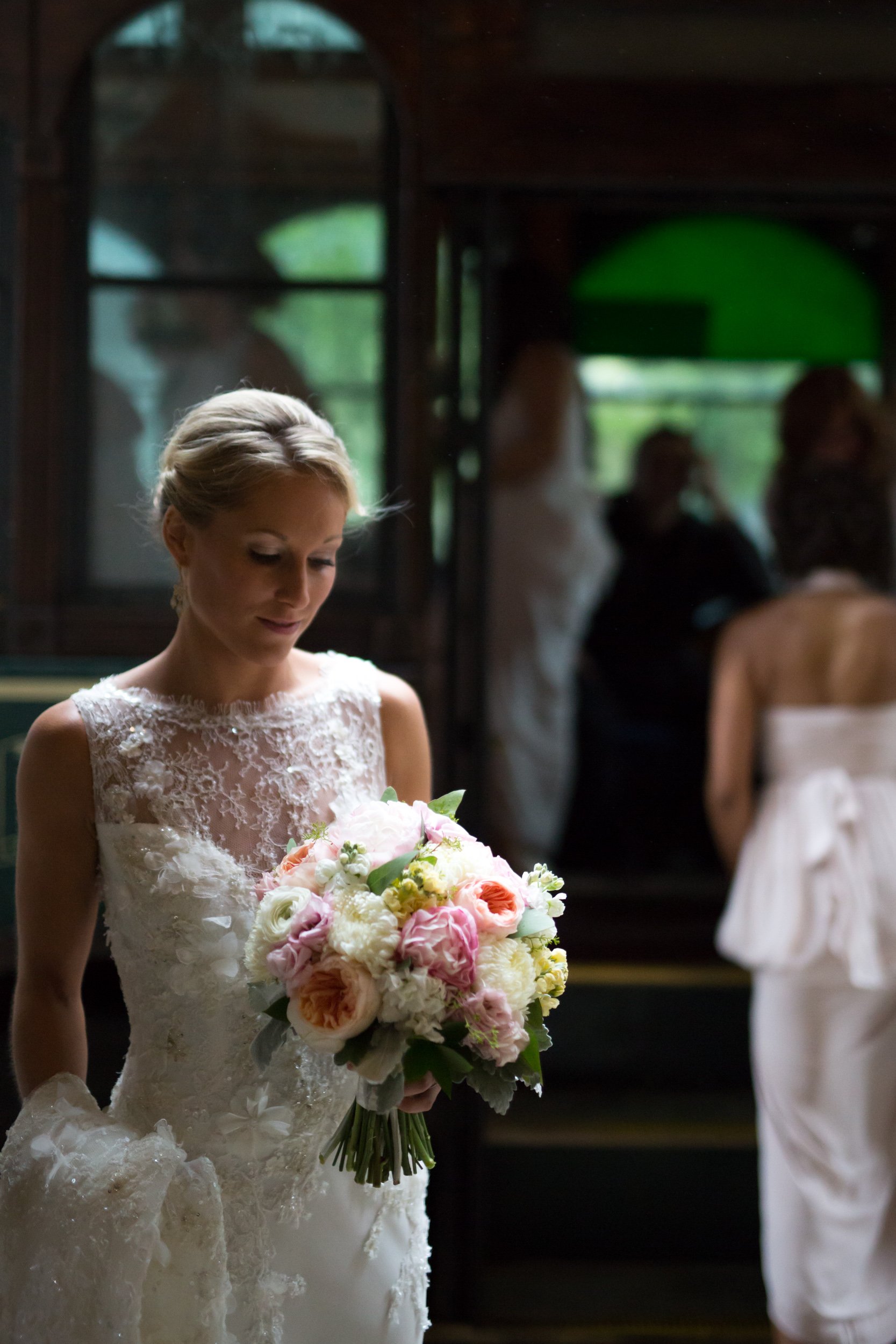 bride looking at her flowers bouquet in the rain Chicago wedding photography