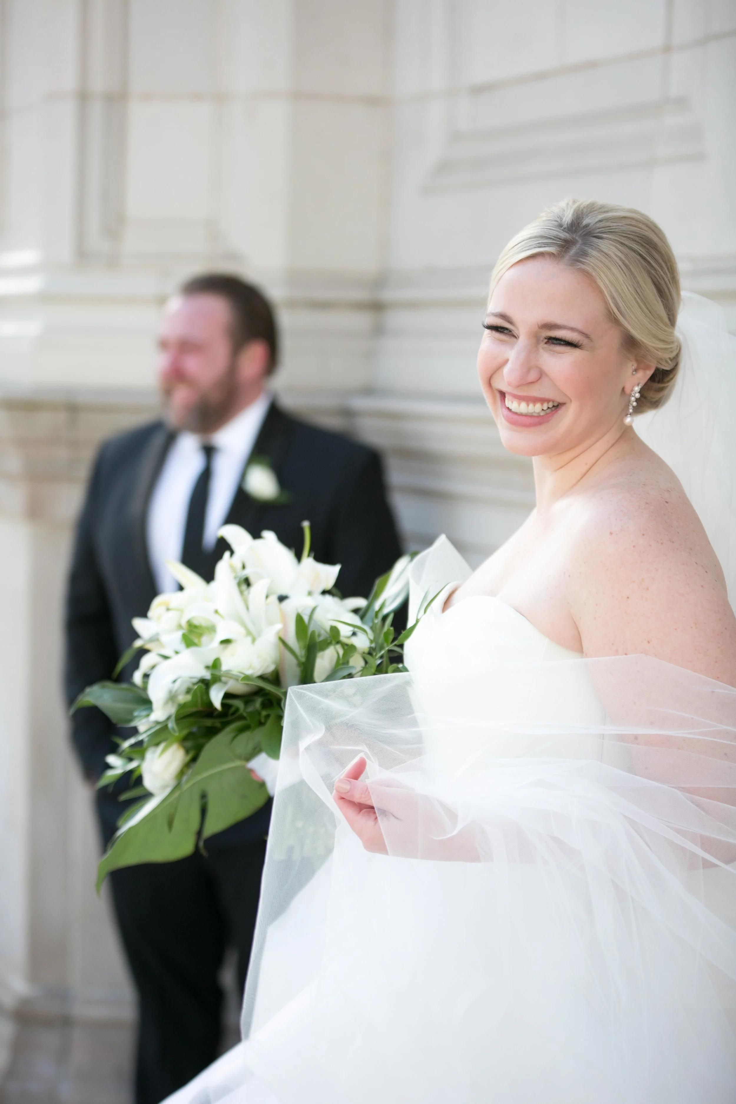 bride smiling portrait with groom Chicago downtown Wrigley Building wedding photography packages