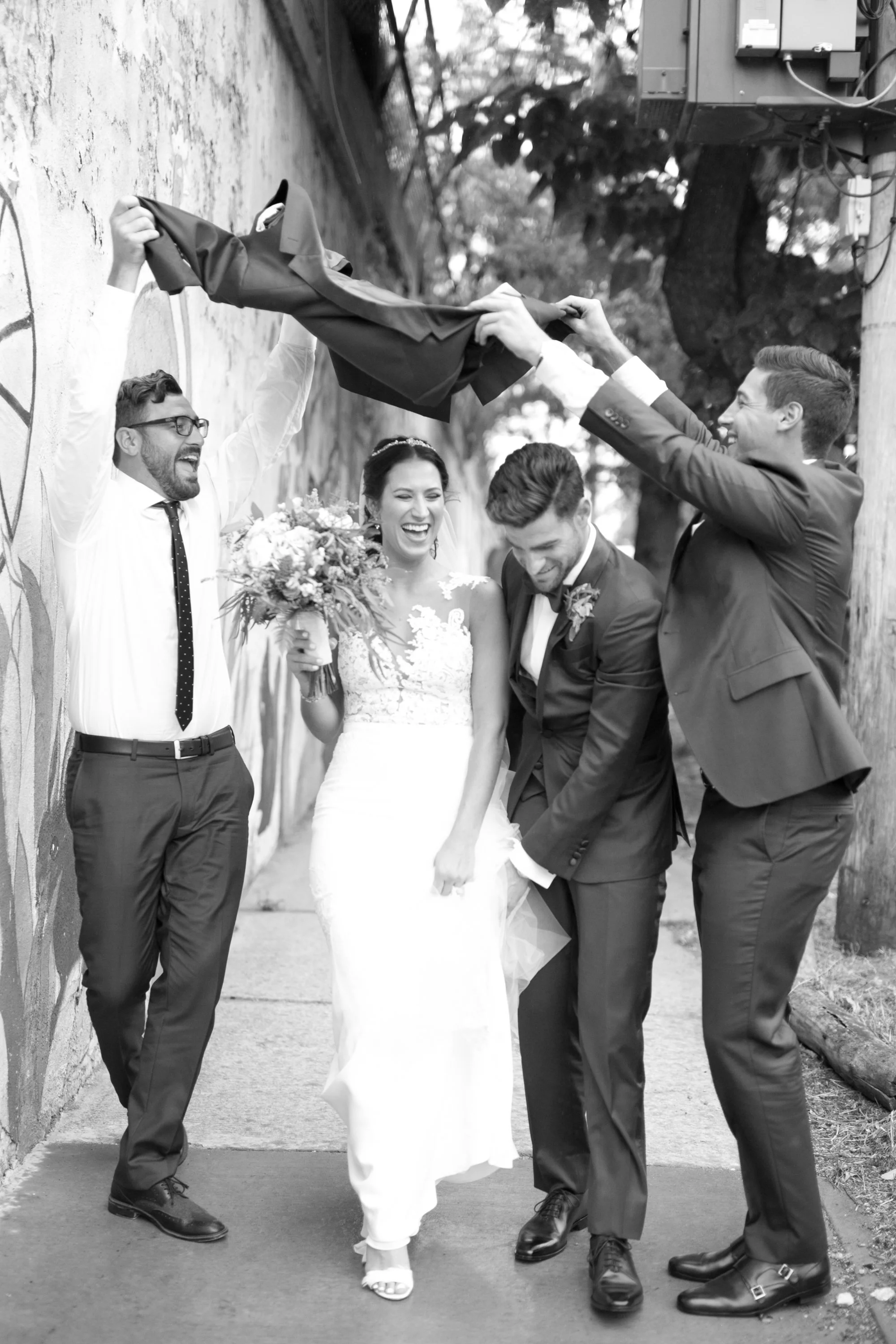 bride and groom walking on sidewalk in the rain Chicago wedding photographer near me