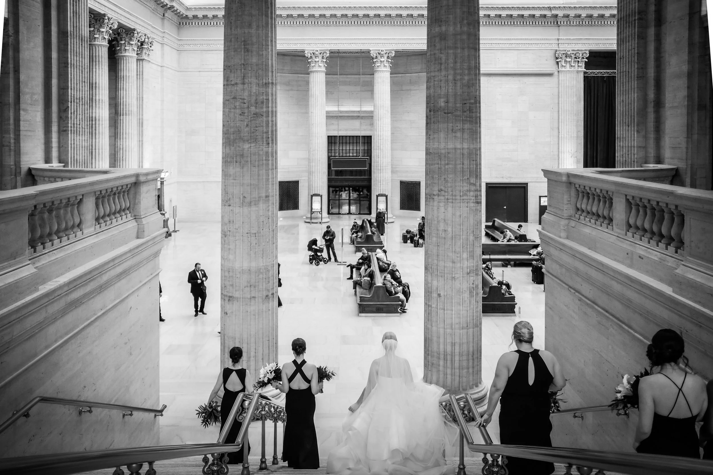 bride with groom Chicago downtown Union station walking down steps wedding photography packages
