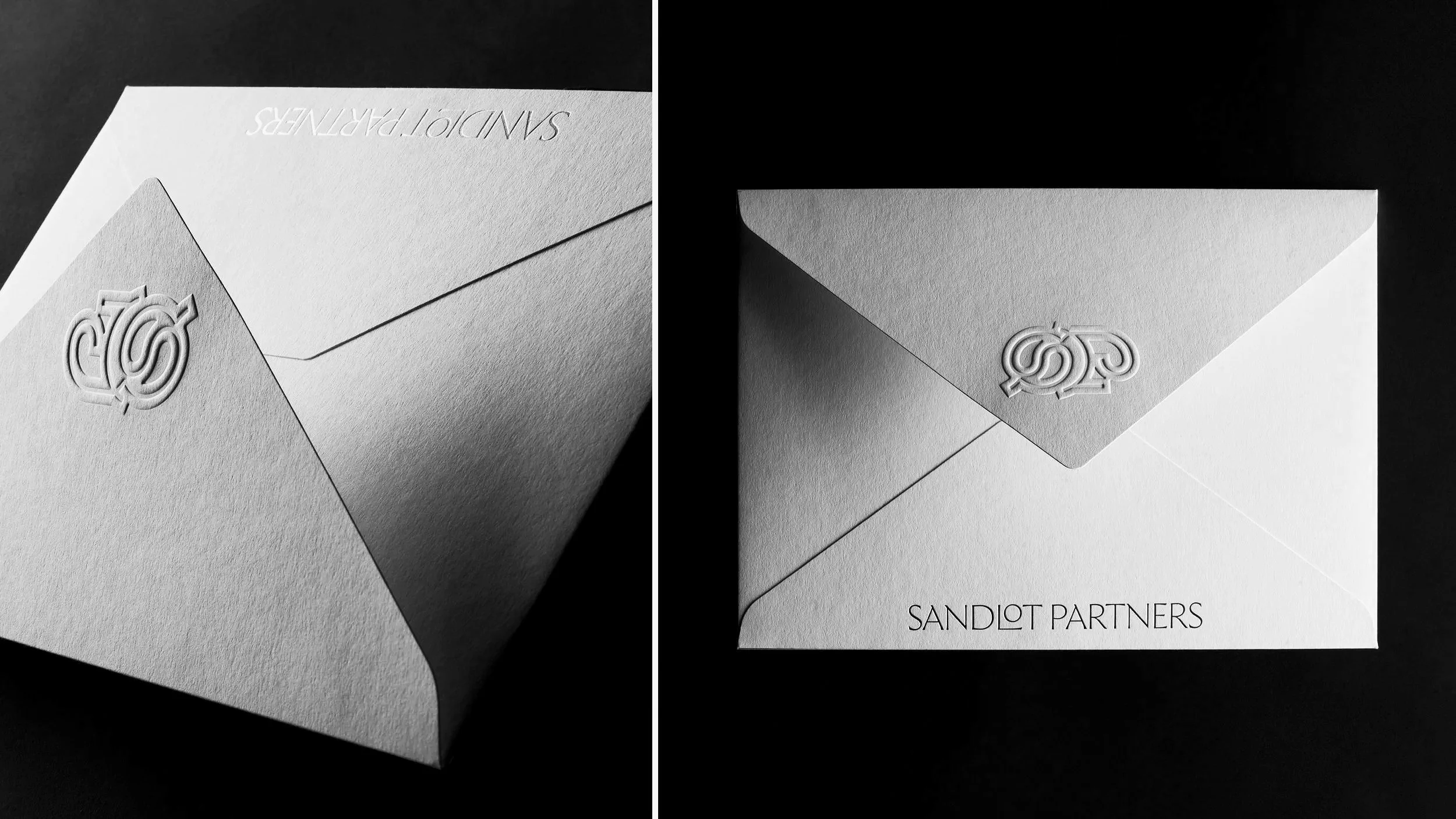 A black and white photograph of an embossed envelope with the logo of SANDIOT PARTNERS on it.