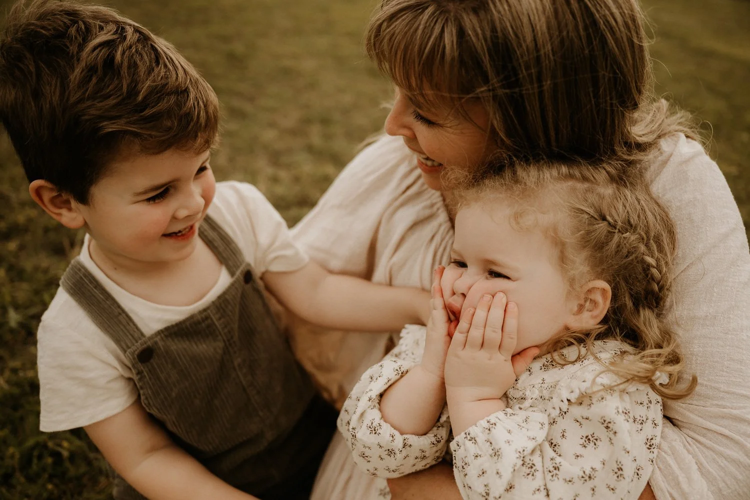 Mum and two children laughing during family photo shoot