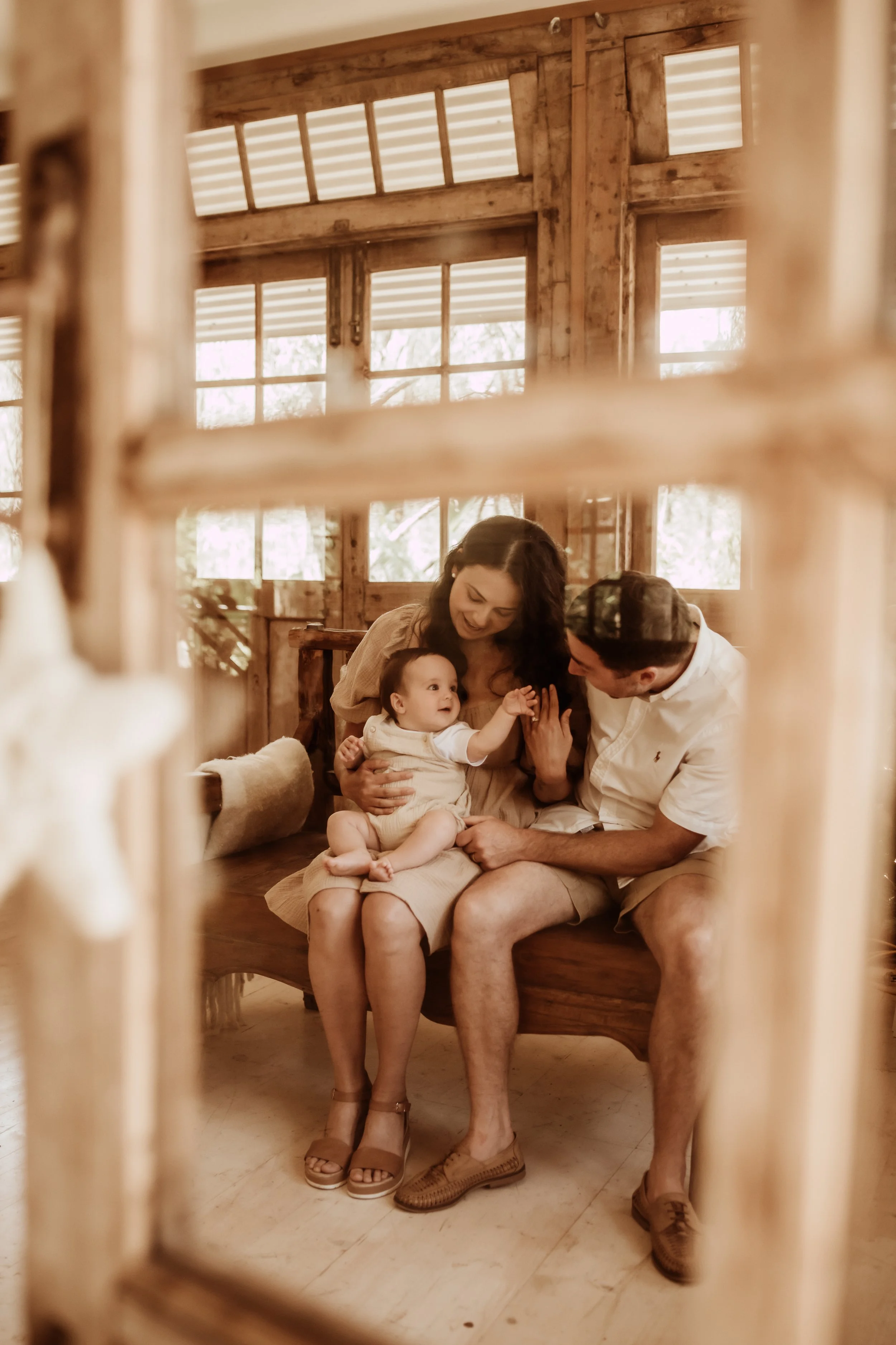 family of three posing for christmas photo