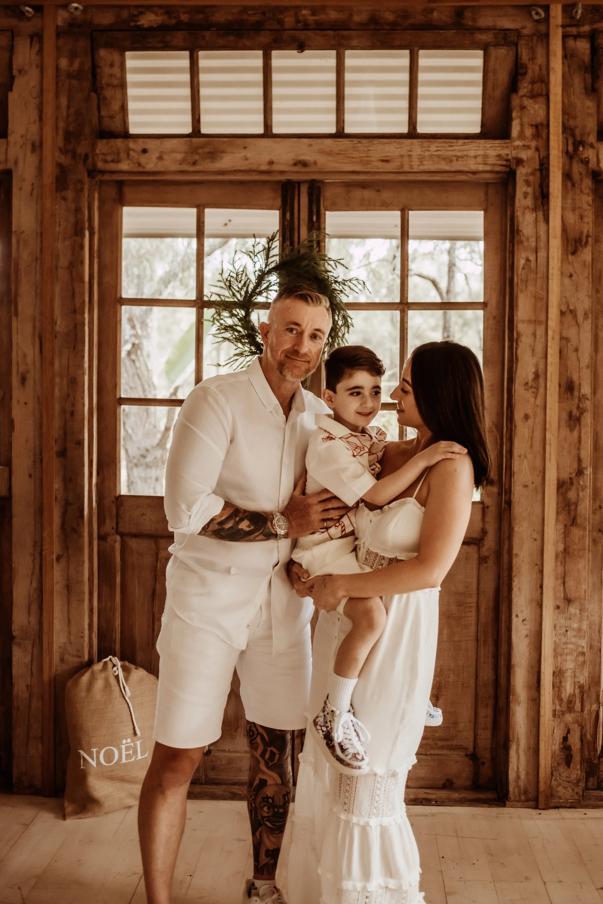 family of three posing for christmas photo