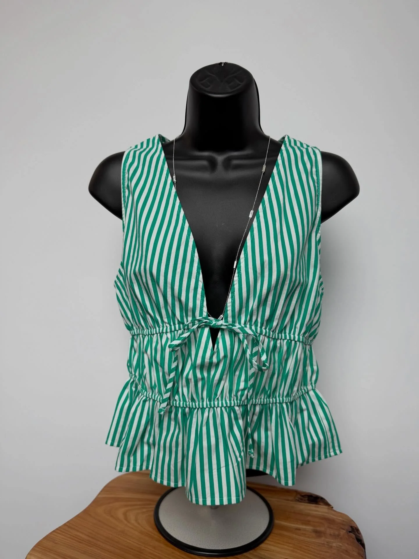 Meet your new favorite statement top 💚
This green striped sleeveless blouse features a deep v-neckline, adjustable front tie detail, and the cutest peplum hem for a flattering, feminine fit.

Available in sizes S-L / Retails for $28 ✨
