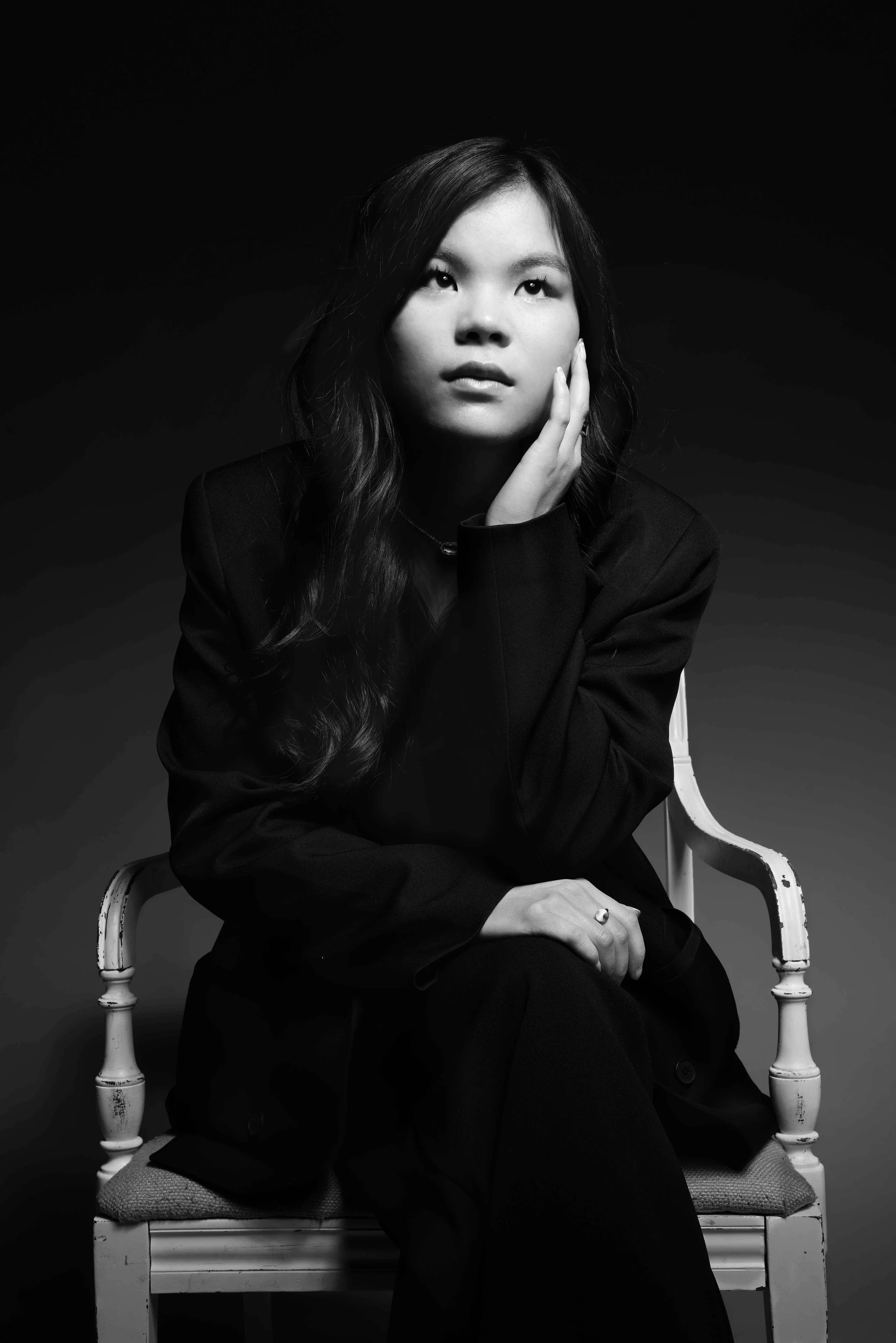 Asian American woman sitting in chair during portrait session 