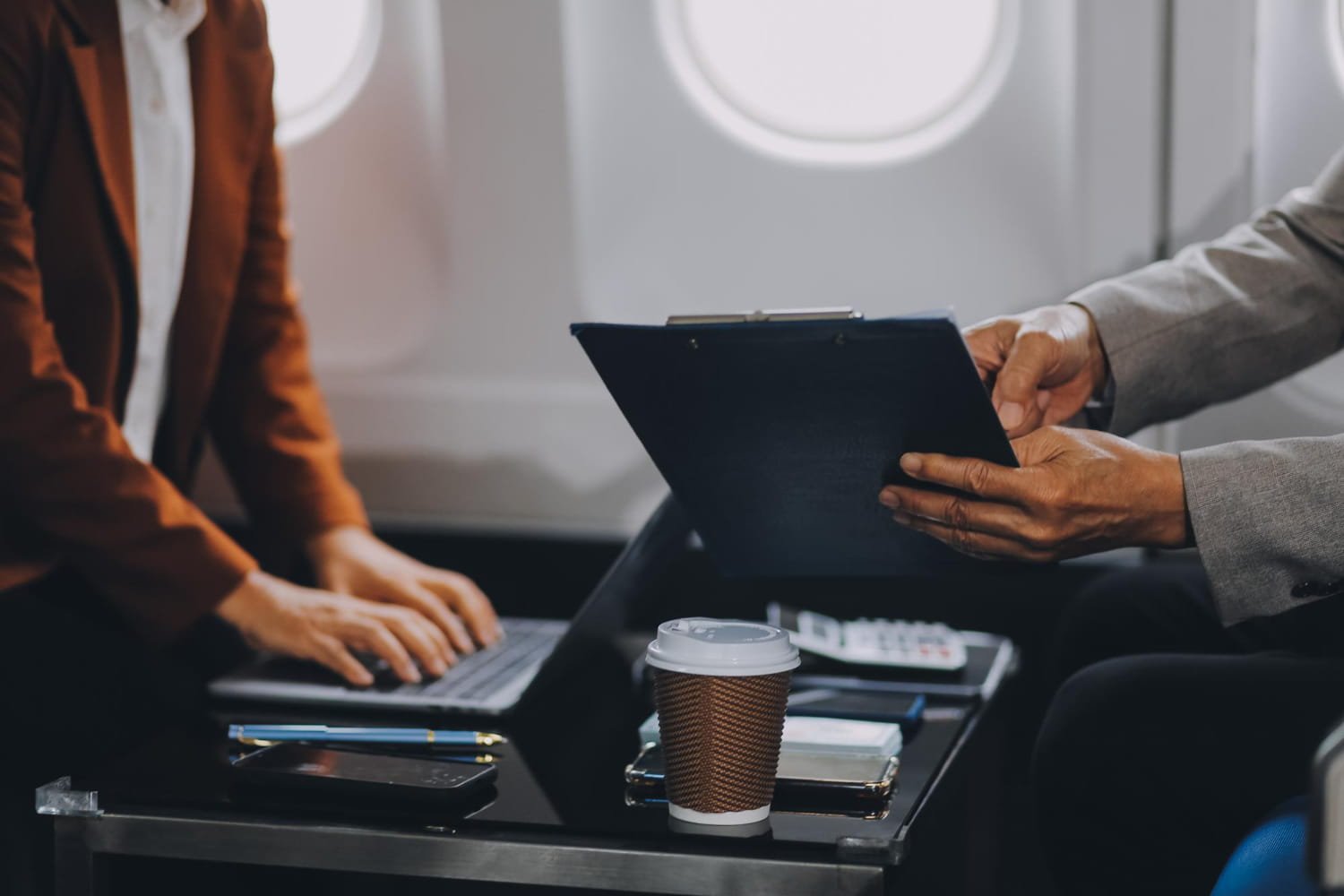 Business travelers reviewing expense documents and compliance records
