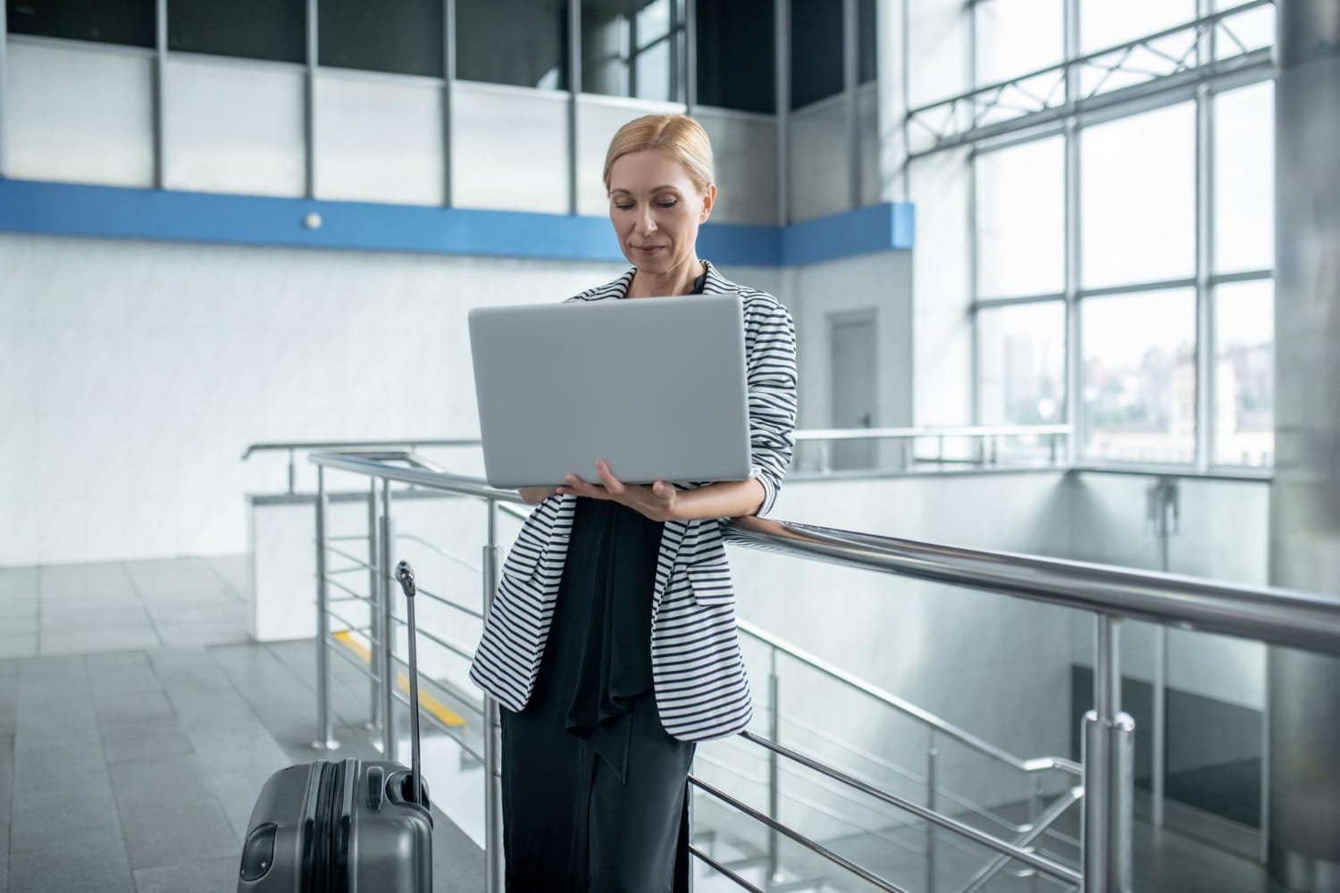 Traveler reviewing corporate travel compliance details on a laptop