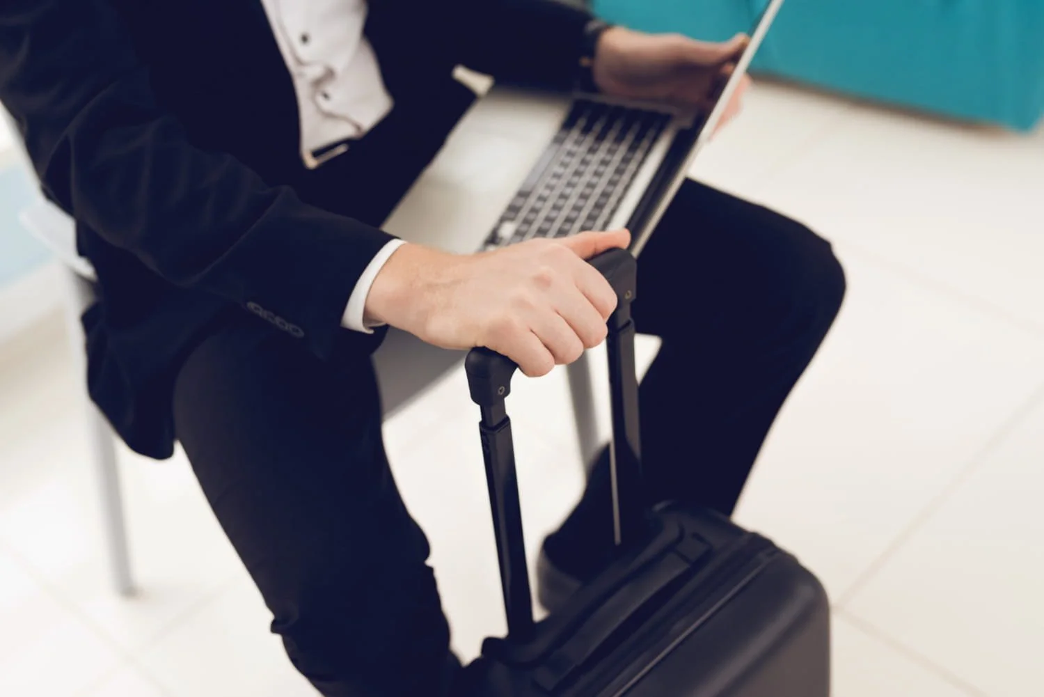 Business traveler with laptop and suitcase
