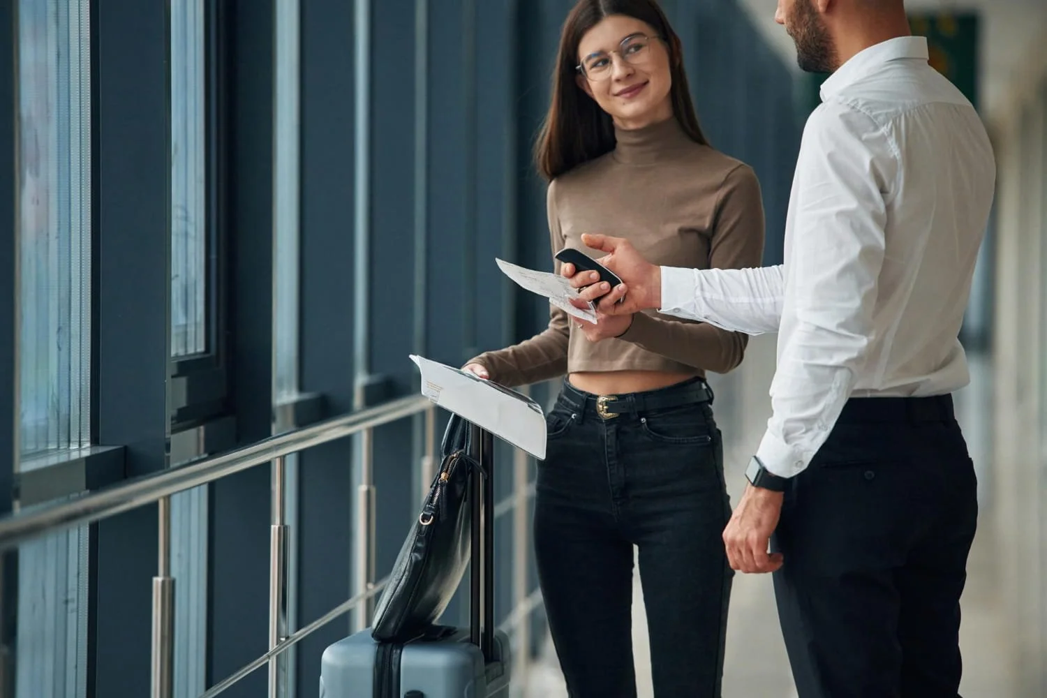 Business travelers discussing travel documents and safety plans