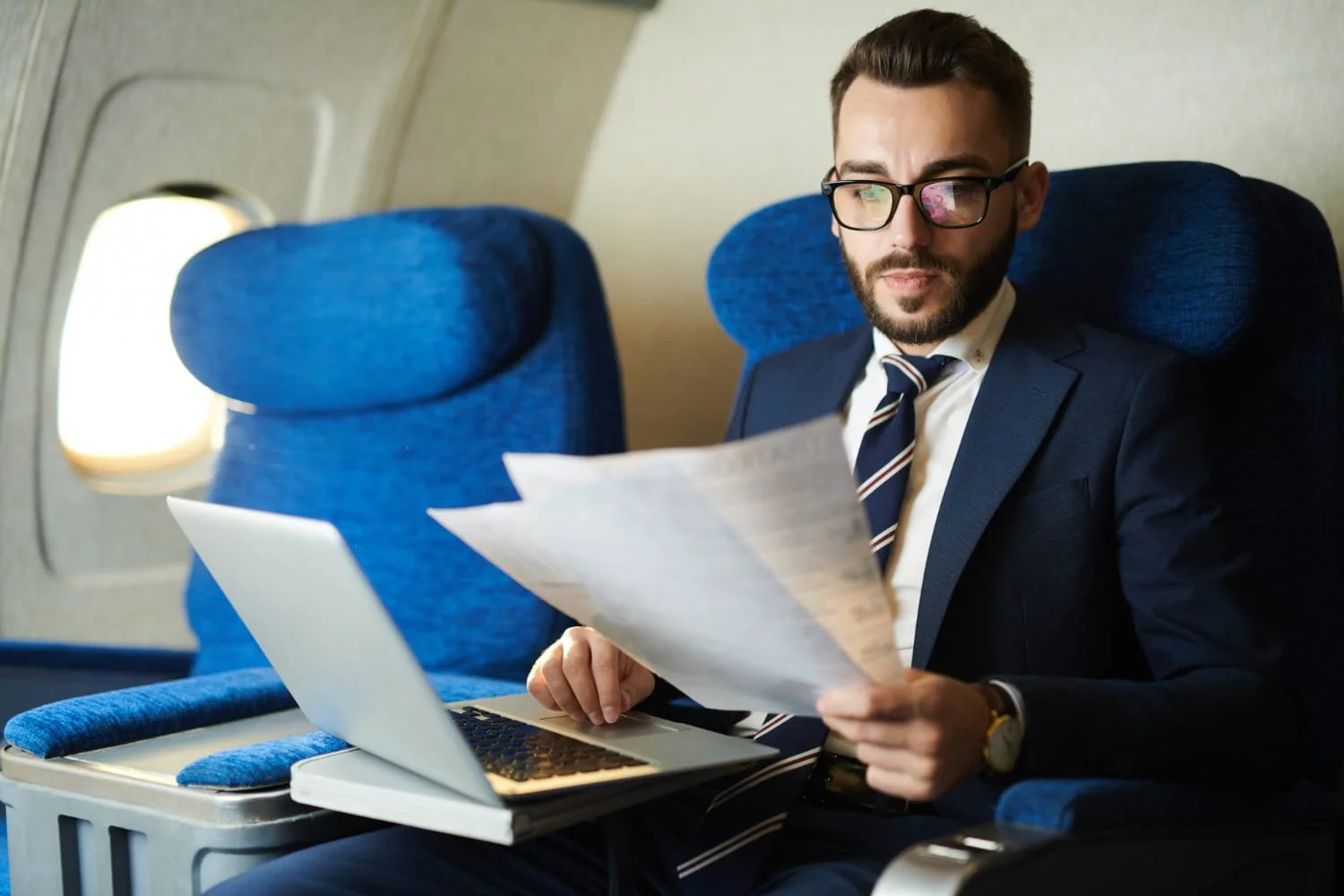 Employee reviewing documents during business travel